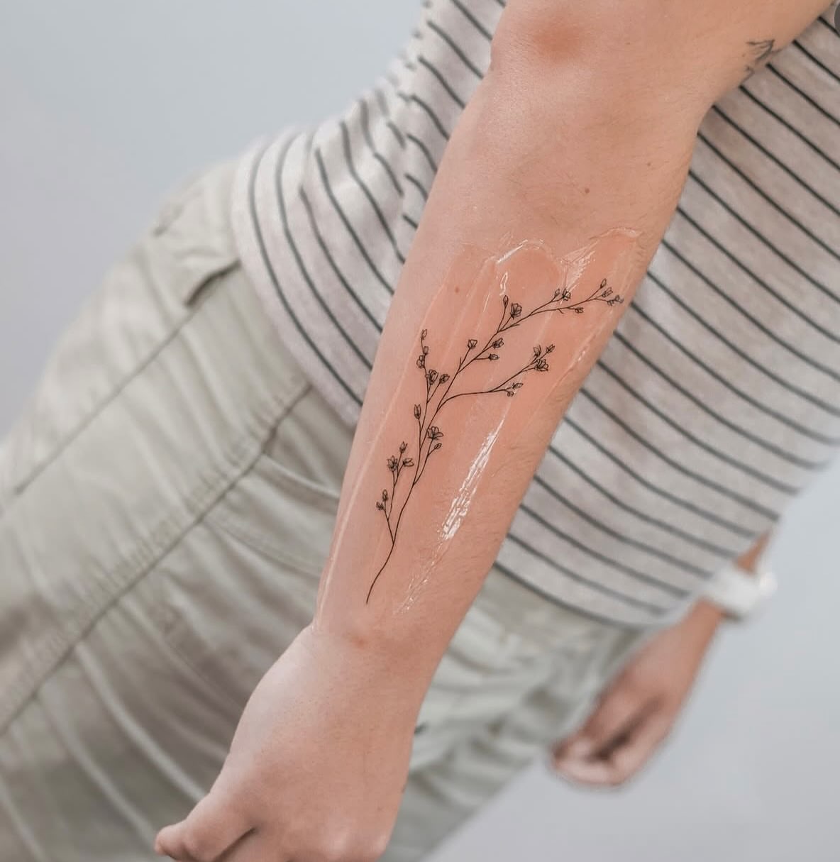 Branch with flowers fine line tattoo on the forearm by Chelsea 🍀 Fine Line Tattoo Artist 🖊️🖊️🖊️, Houston, Texas