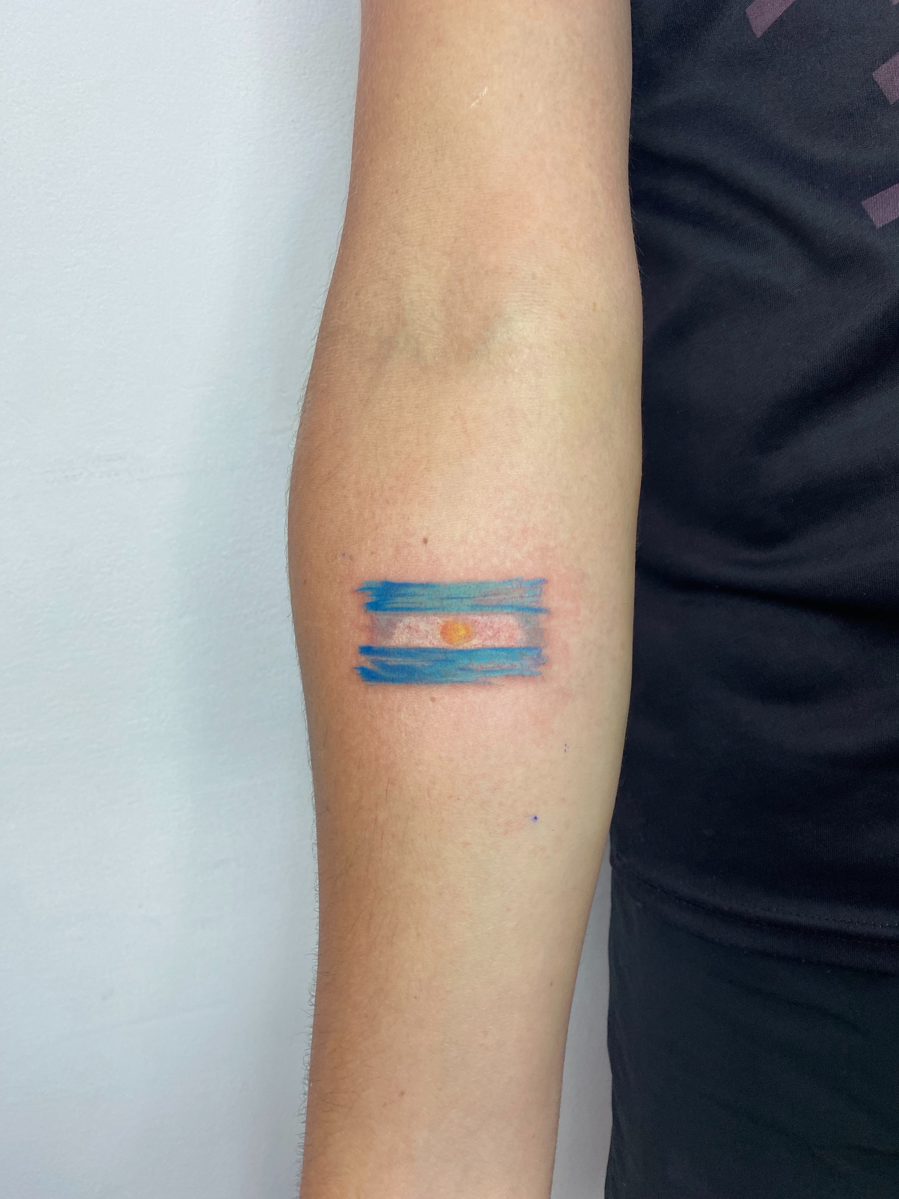 Argentine flag watercolor tattoo on the forearm by Eleana, North Miami, Florida