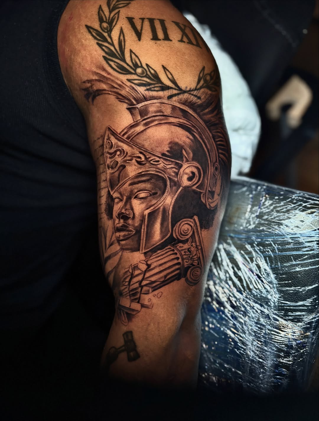 Roman soldier's helmet and face realism tattoo on the forearm by Koolz