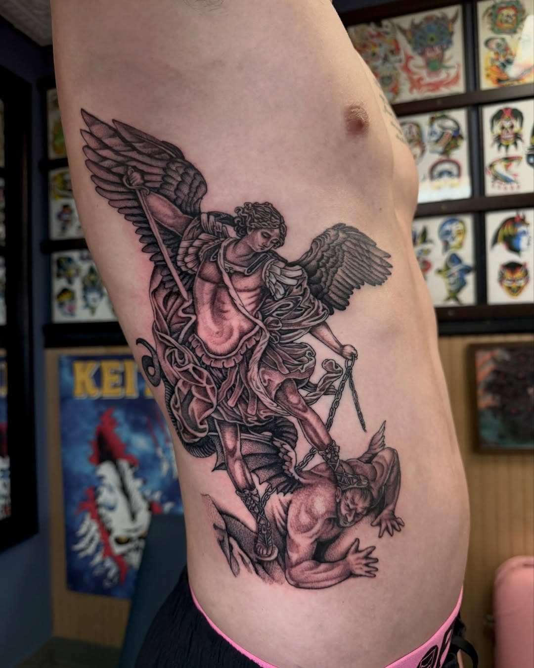 Archangel Michael battling a demon realism tattoo on the ribs by ⛓ Emily ⚔️ Milja ⛓