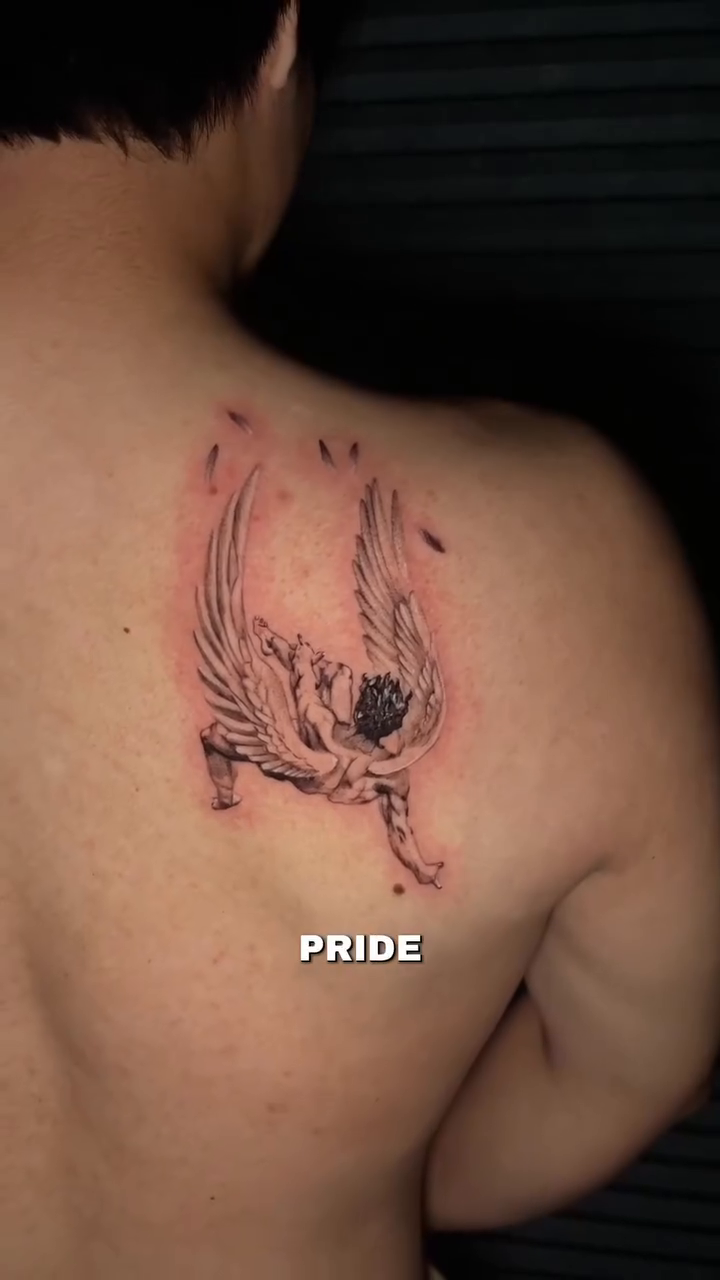 Fallen angel with text realism tattoo on the back by clarissa