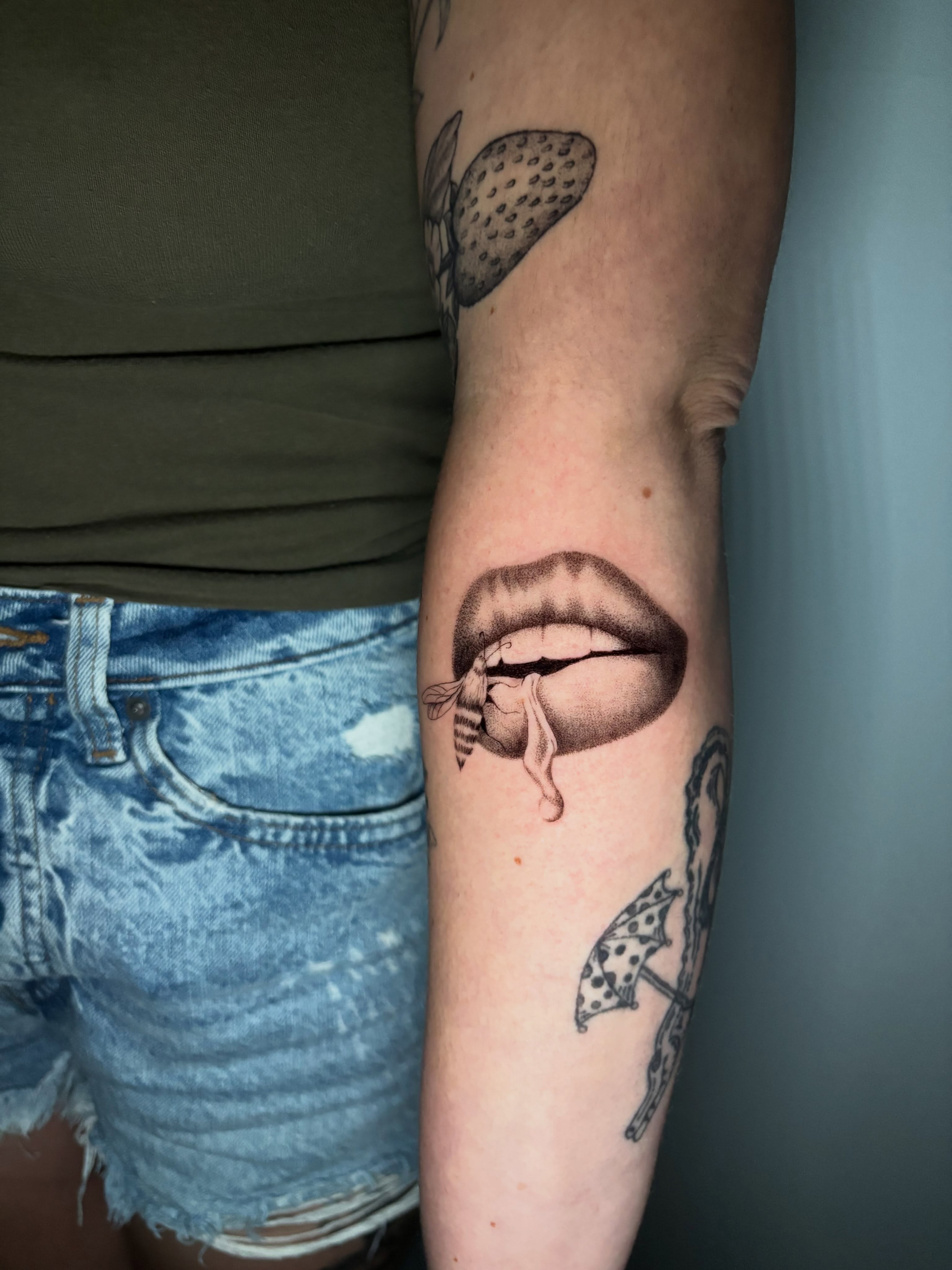 Lips with bee realism tattoo on the forearm by Jojo Rose ✨ Denver Tattoo Artist