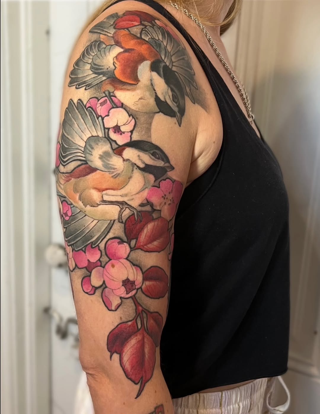 Chickadees and cherry blossoms watercolor tattoo on the upper arm by Tex Buss, San Francisco, California