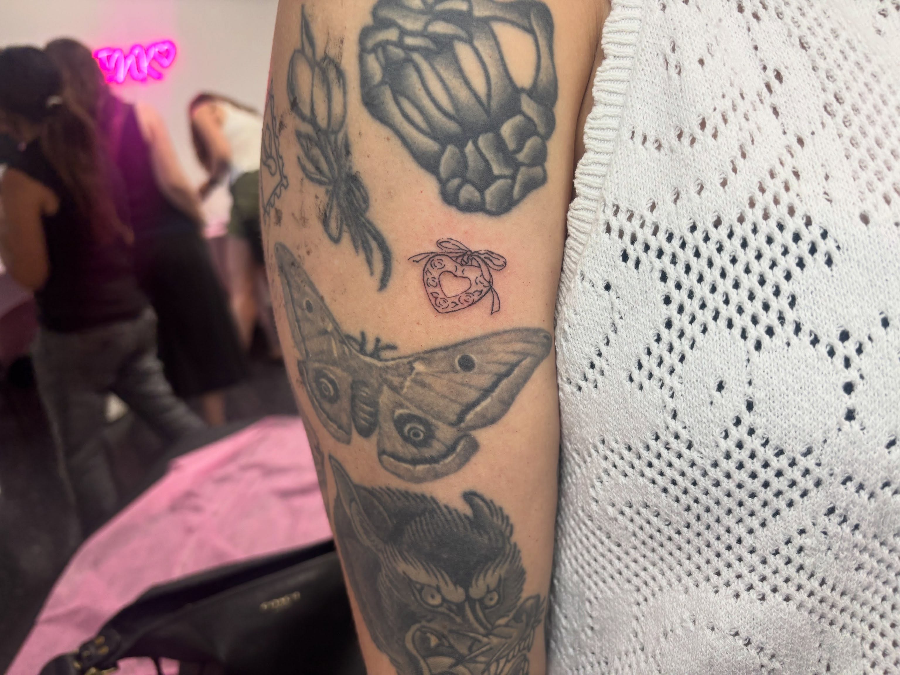 Butterfly and heart black and grey tattoo on the forearm by Mickey