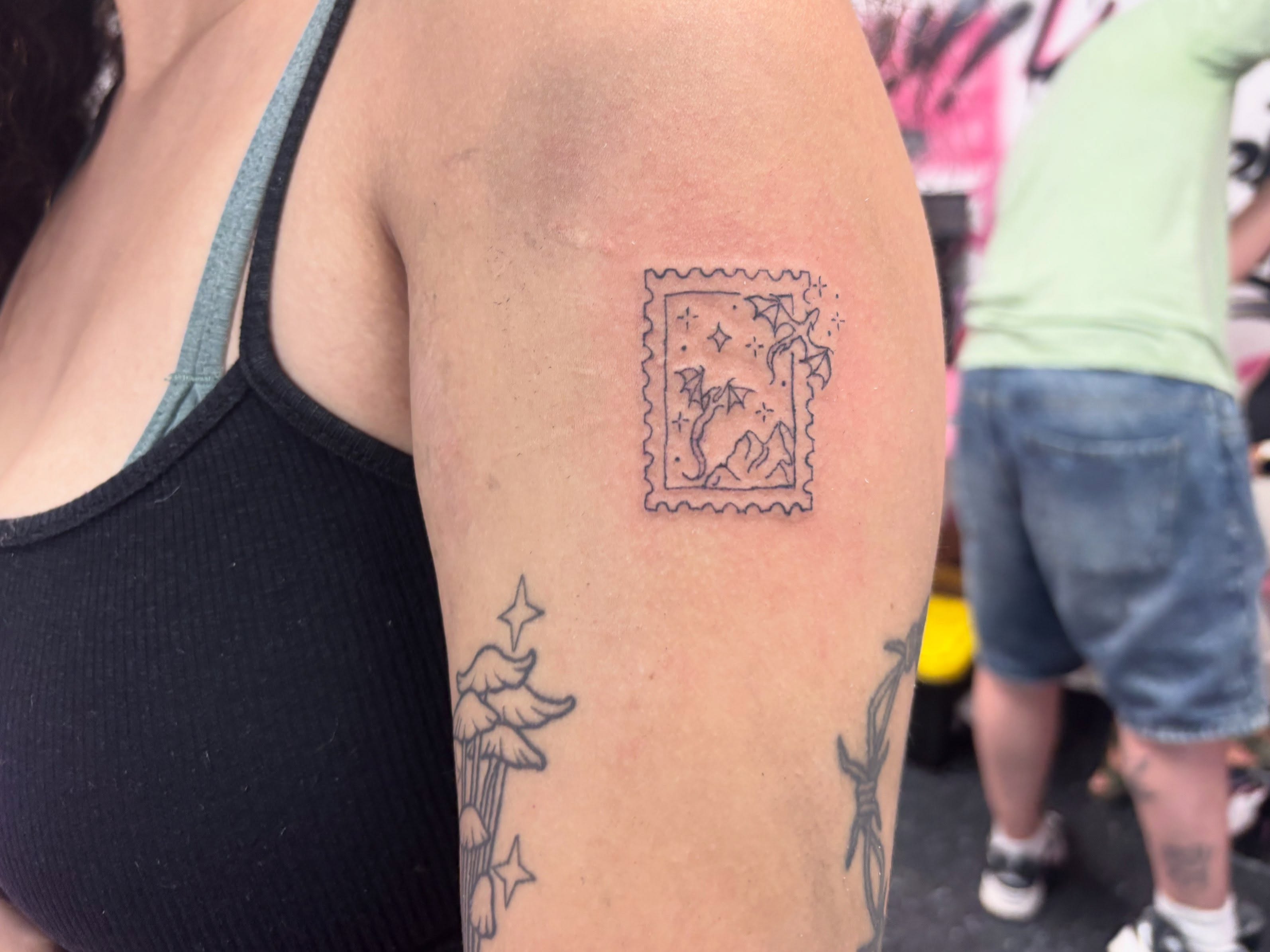 Postage stamp black and grey tattoo on the forearm by Mickey