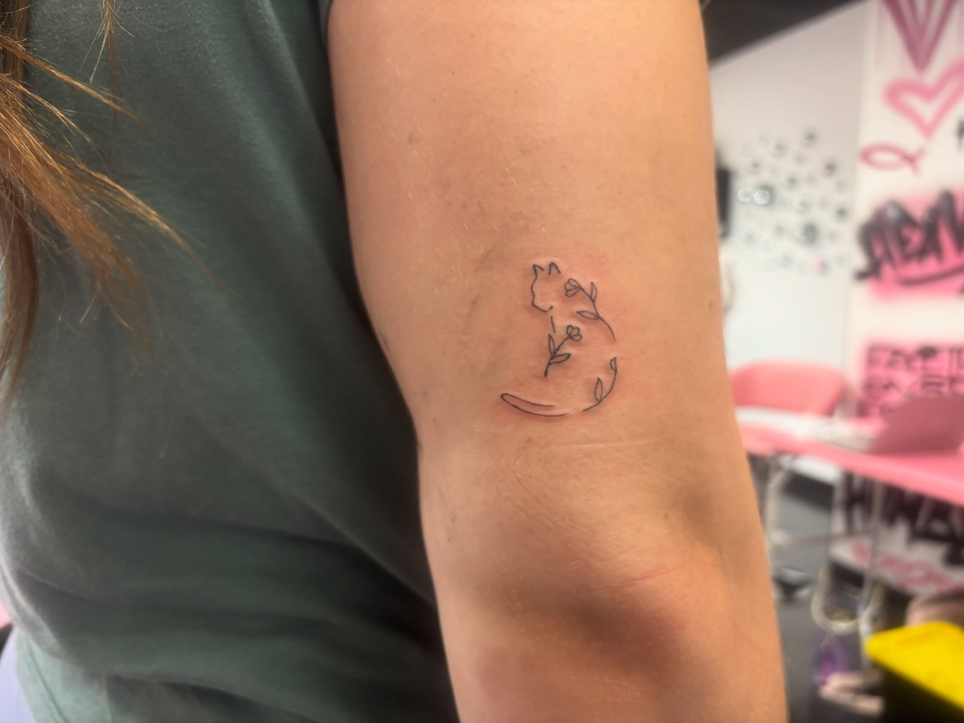Cat and flower fine line tattoo on the forearm by Mickey