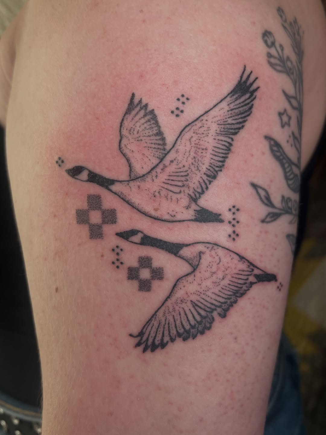 Two flying geese fine line tattoo on the upper arm by faith
