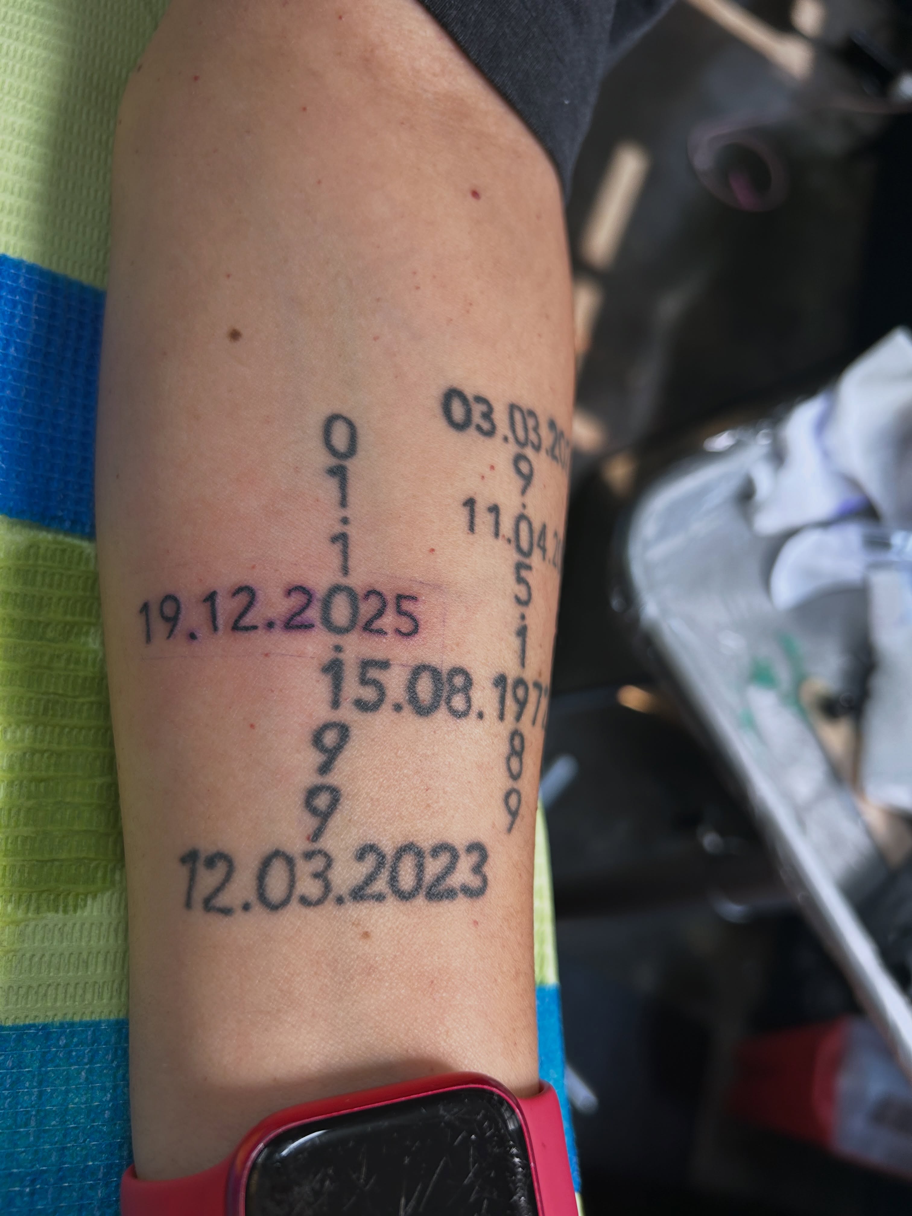 Numbers and dates lettering script tattoo on the forearm by Carlen Gil