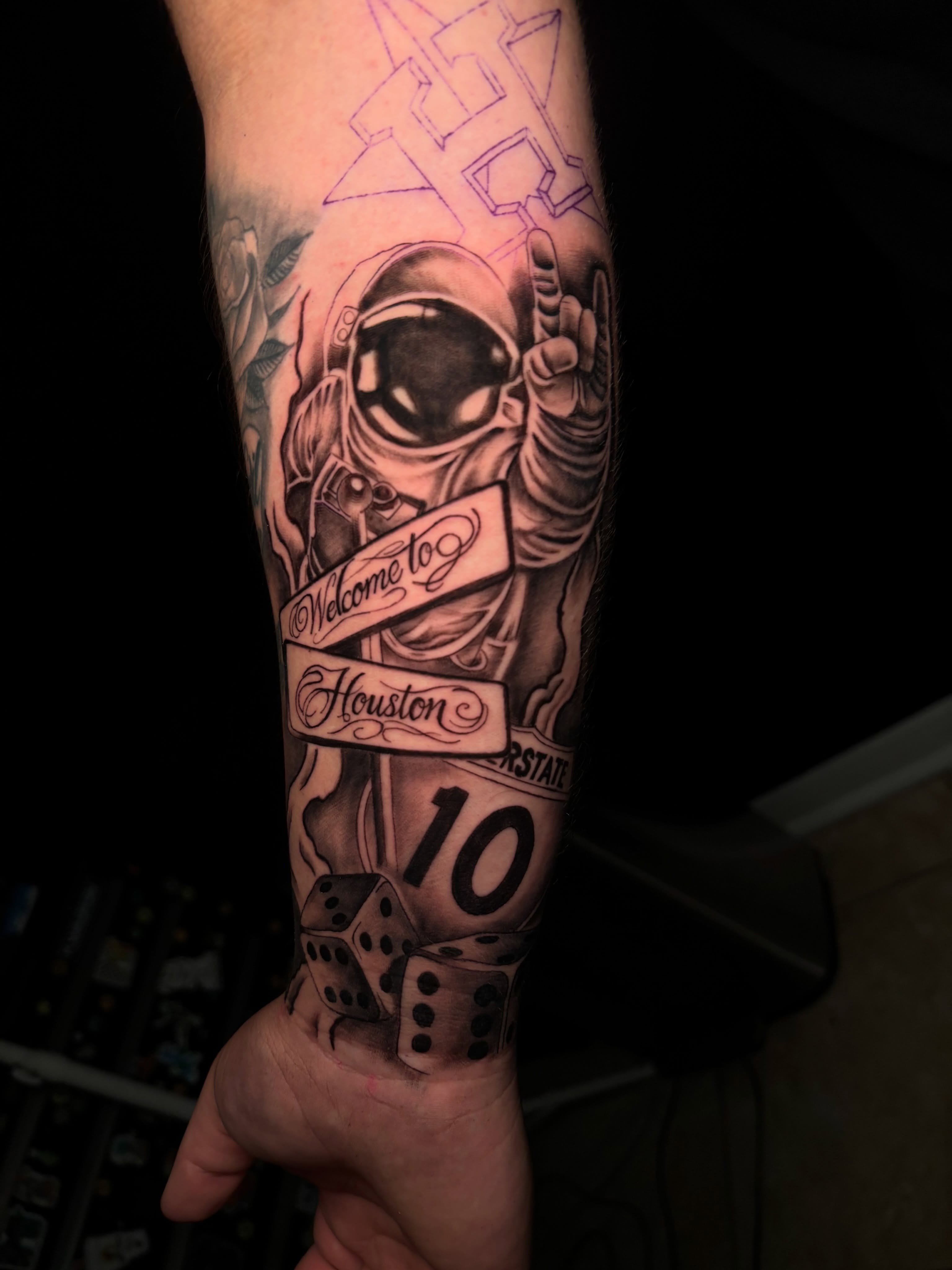 Astronaut with banner realism tattoo on the forearm by Thomas