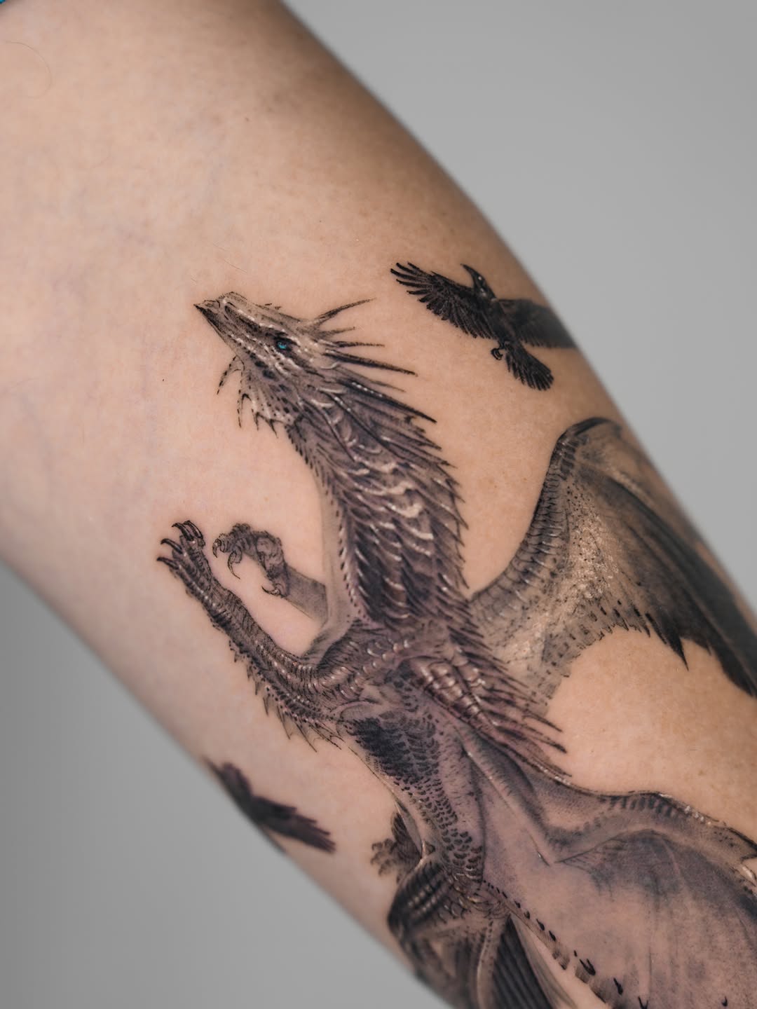 Dragon and ravens Japanese tattoo on the forearm by Jun