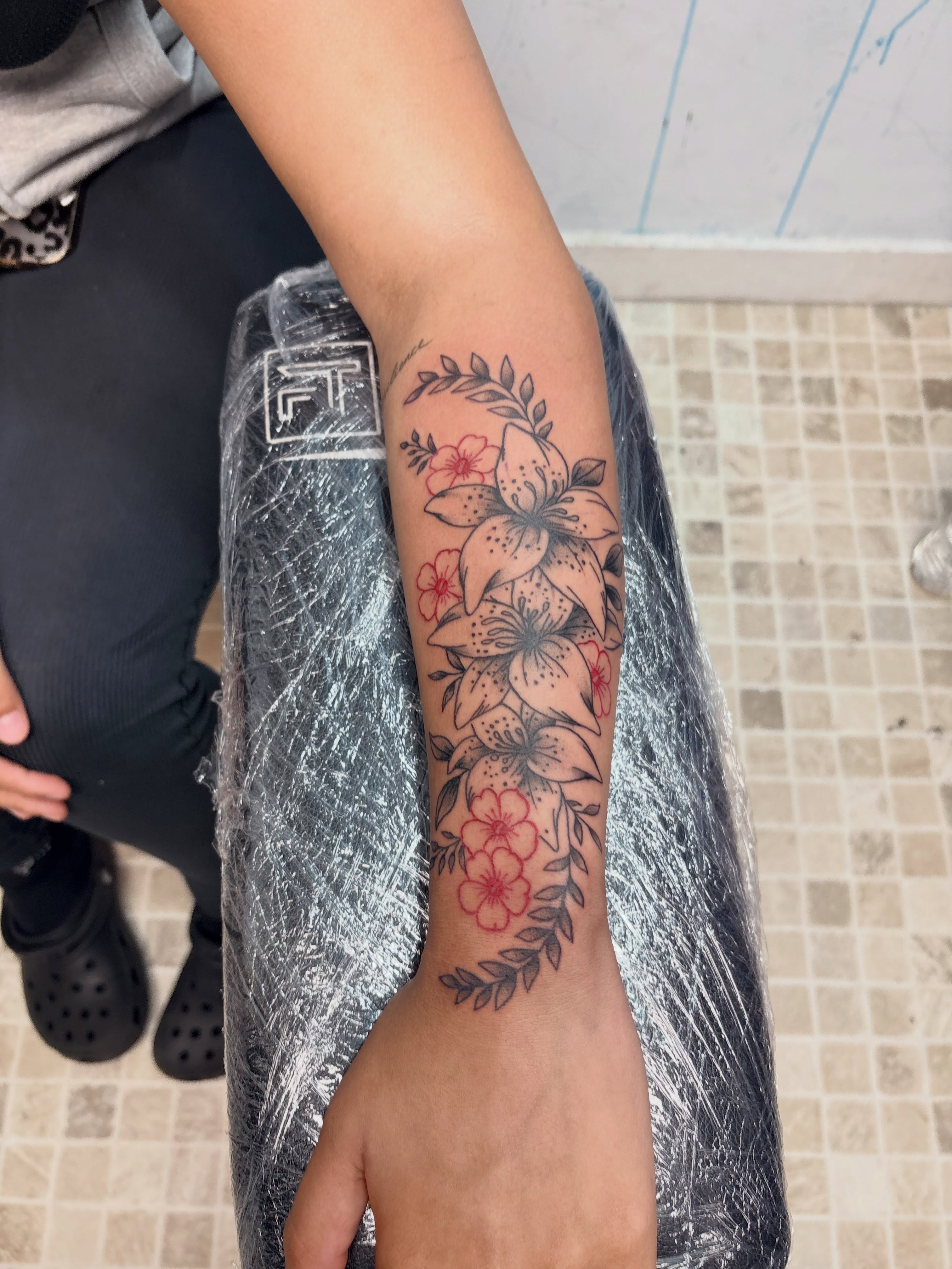 Lily flowers black and grey tattoo on the forearm by 𝓚𝓪𝓻𝓶𝓪💫