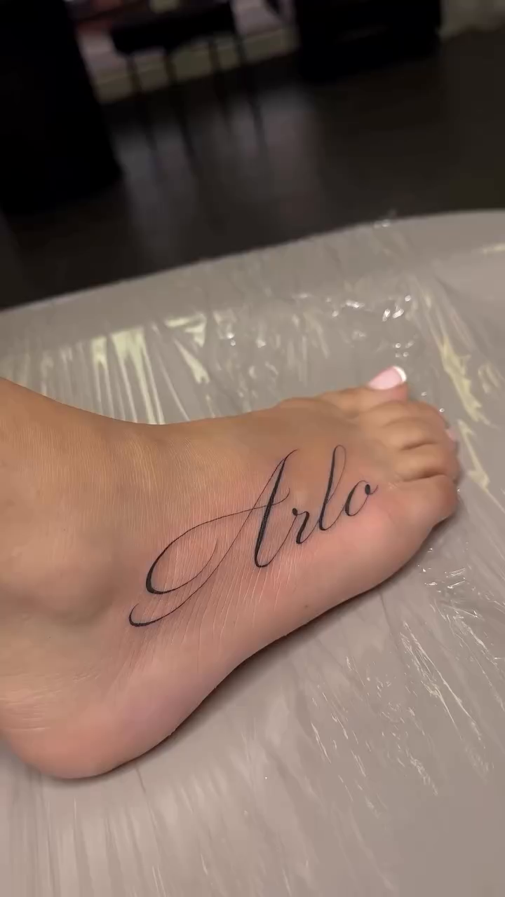 Arlo script tattoo lettering tattoo on the foot by Jennifer Garcia R - Vegas tattoo artist