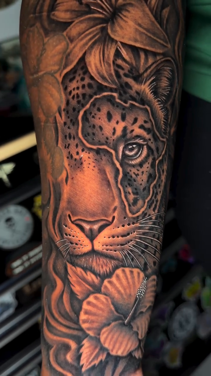 Leopard and flowers realism tattoo by professional tattoo artist