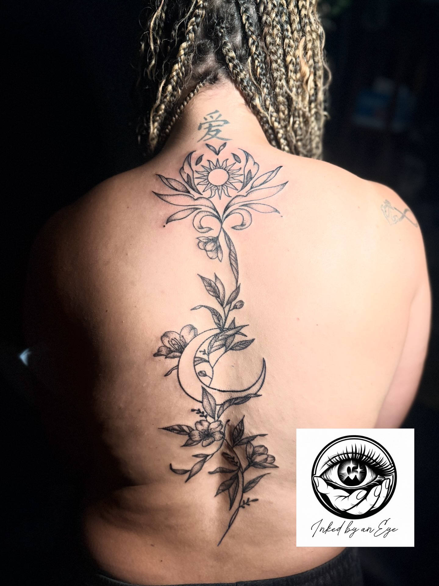 Flower and crescent moon black and grey tattoo on the back by Alesia