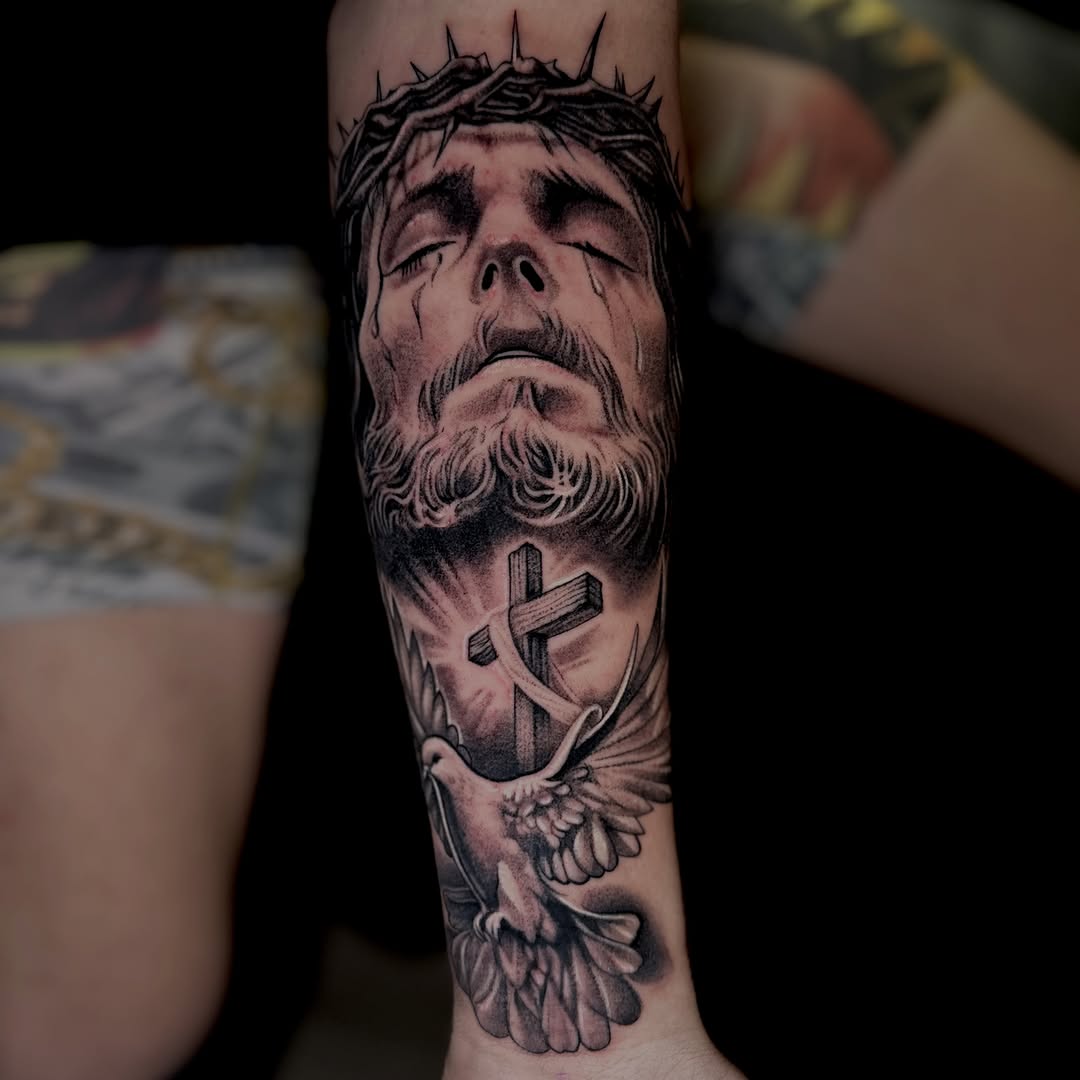 Jesus Christ with cross and dove realism tattoo on the forearm by Big Steve Lewis