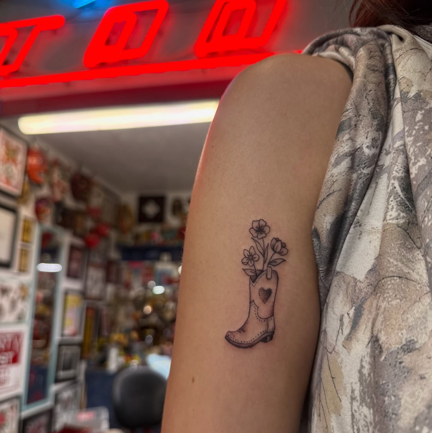Cowboy boot with flowers black and grey tattoo on the forearm by Hannah Edwards, Austin, Texas