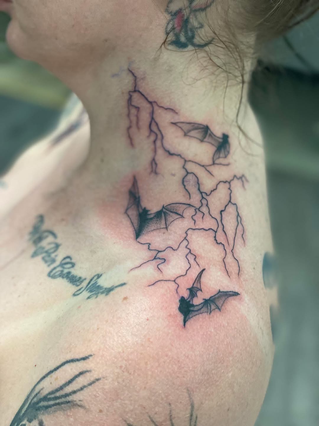 Bats and lightning blackwork tattoo on the neck by Israel Jacob Woehler