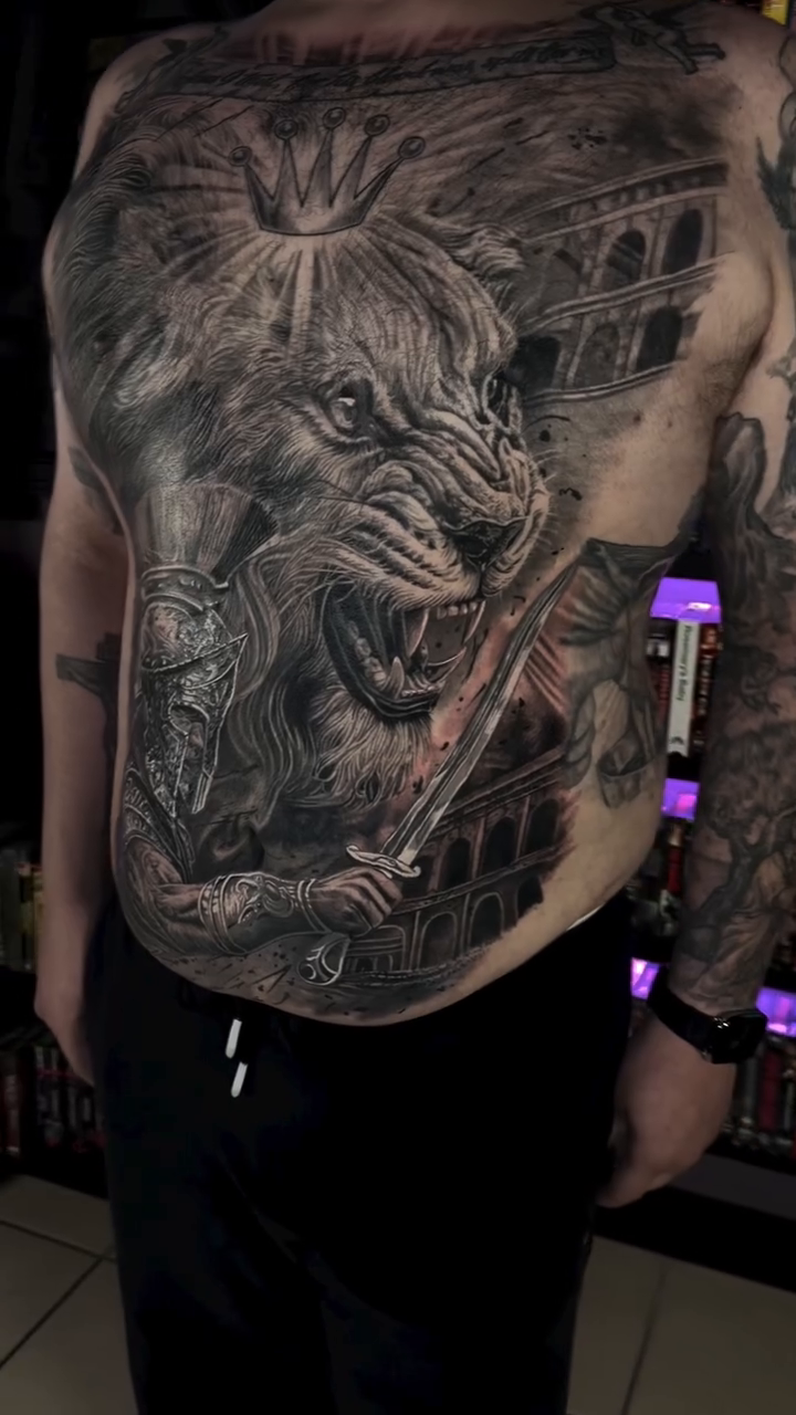 Lion gladiator with Roman colosseum background realism tattoo by Steven Pelkey, Eastpointe, Michigan