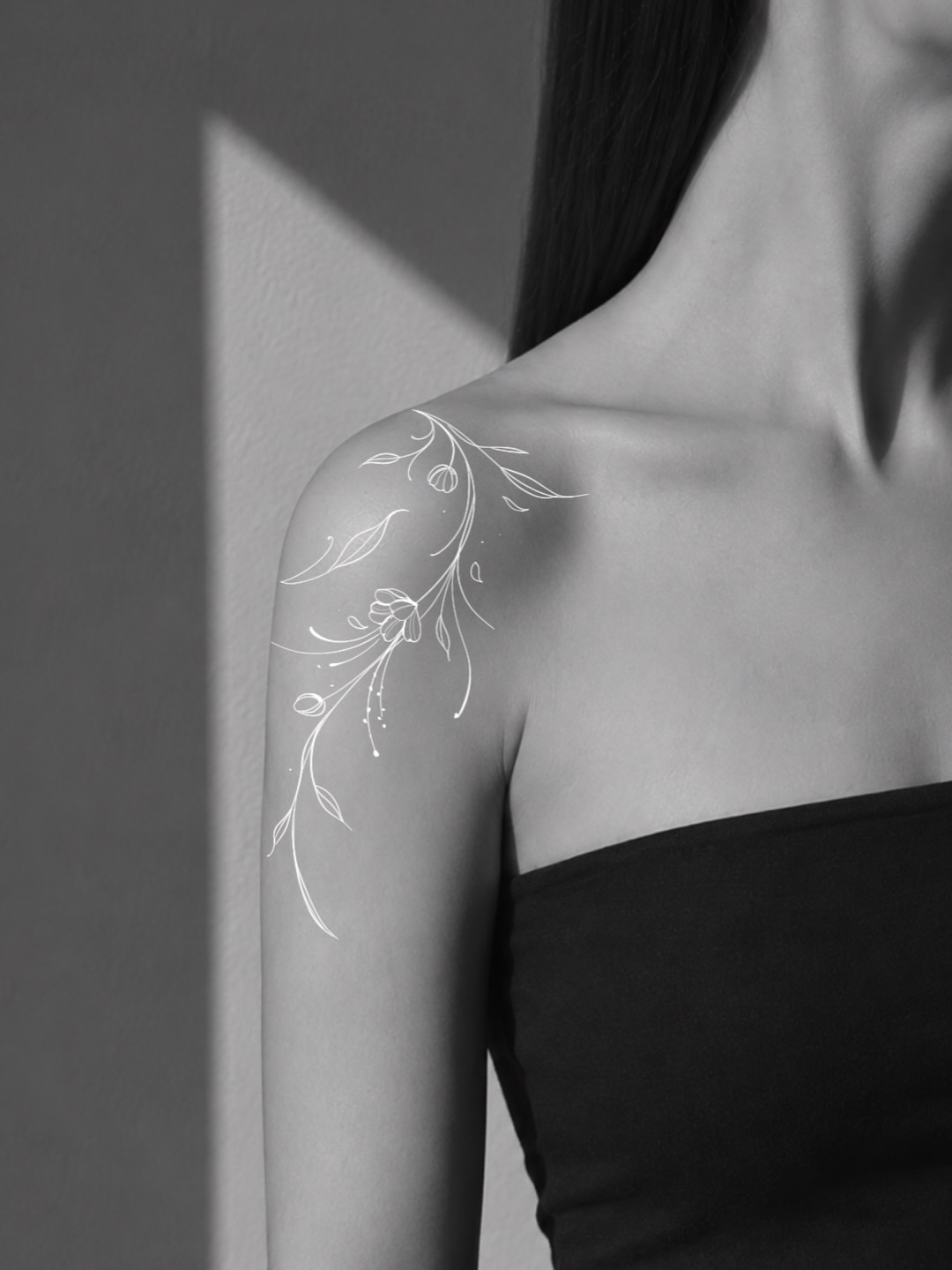 Floral vine fine line tattoo on the shoulder by Victoria