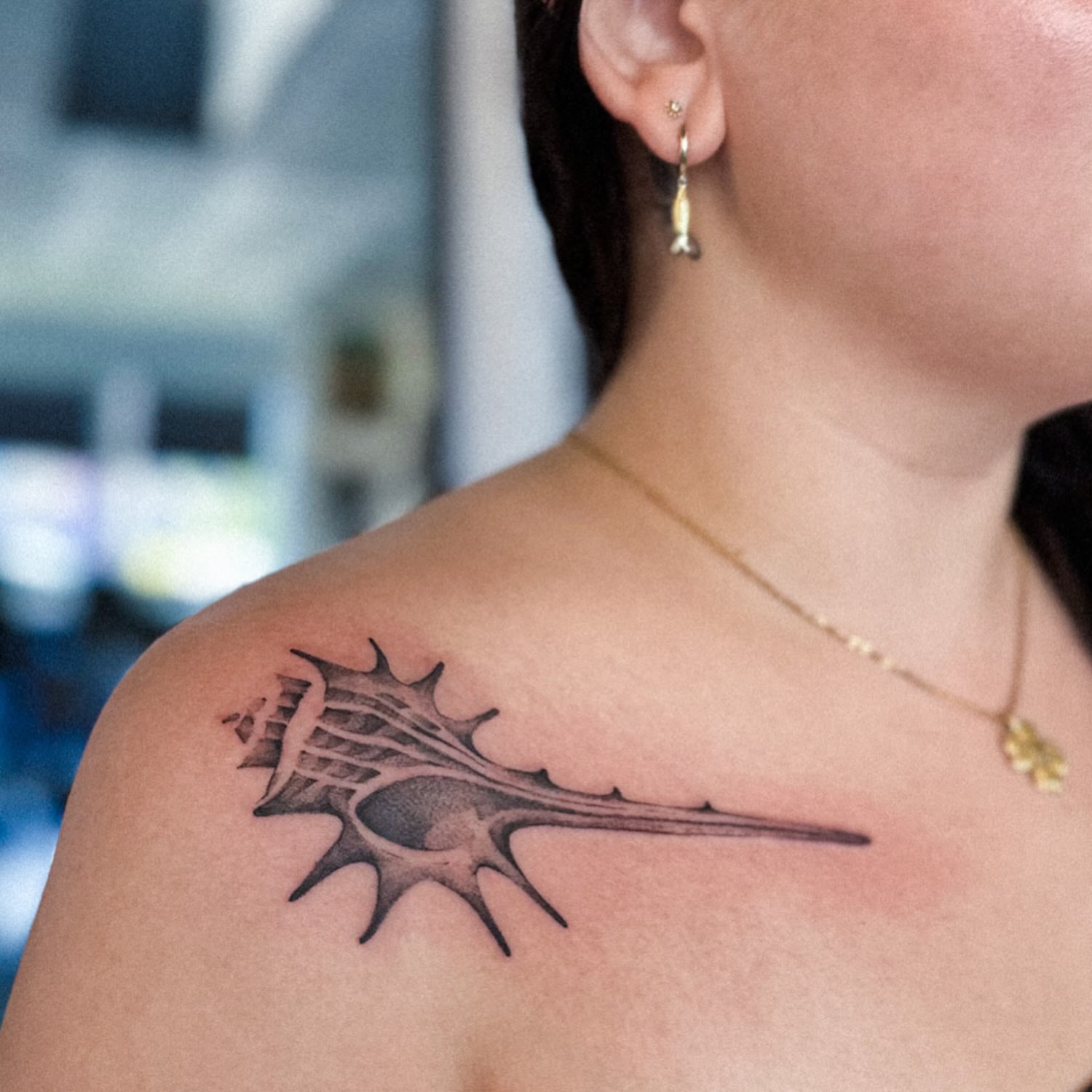 Shell black and grey tattoo on the shoulder by Elvira Savchuk