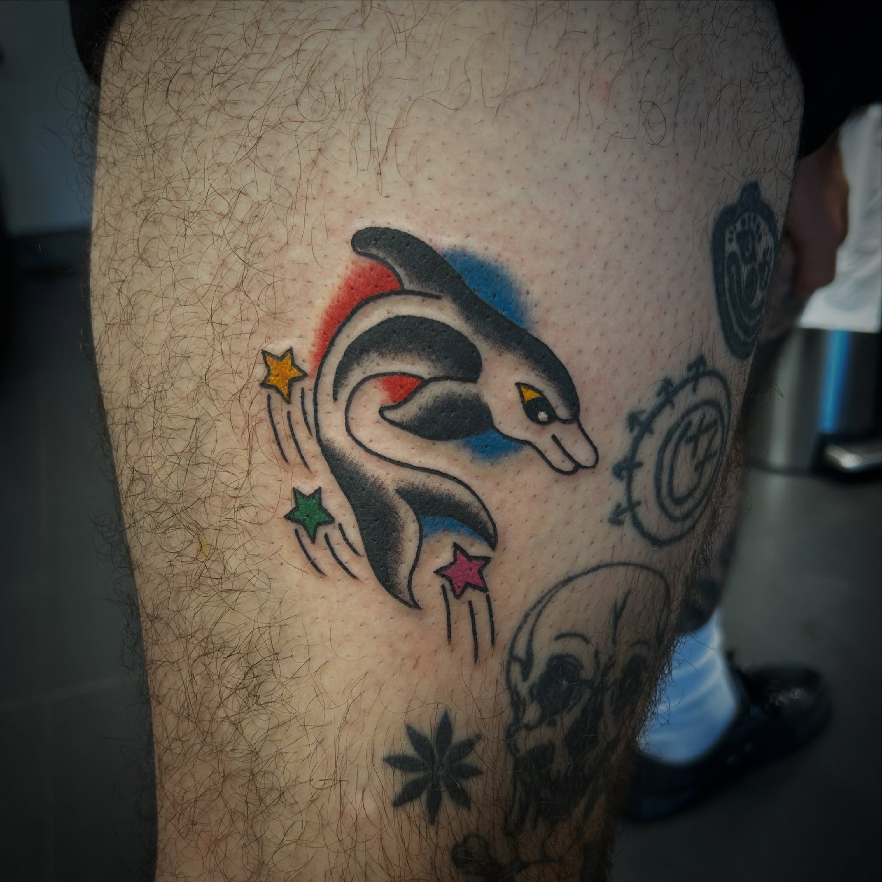 Dolphin American traditional tattoo on the thigh by Tawni Bender