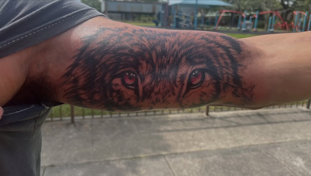 Wolf eyes realism tattoo on the forearm by SpicyMvstardInkk