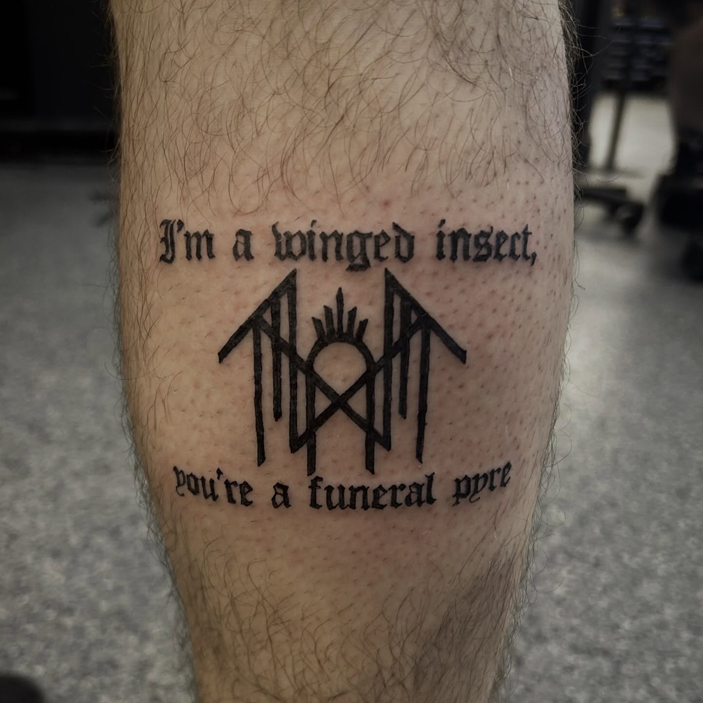 Winged insect funeral pyre lettering script tattoo on the forearm by Gillian