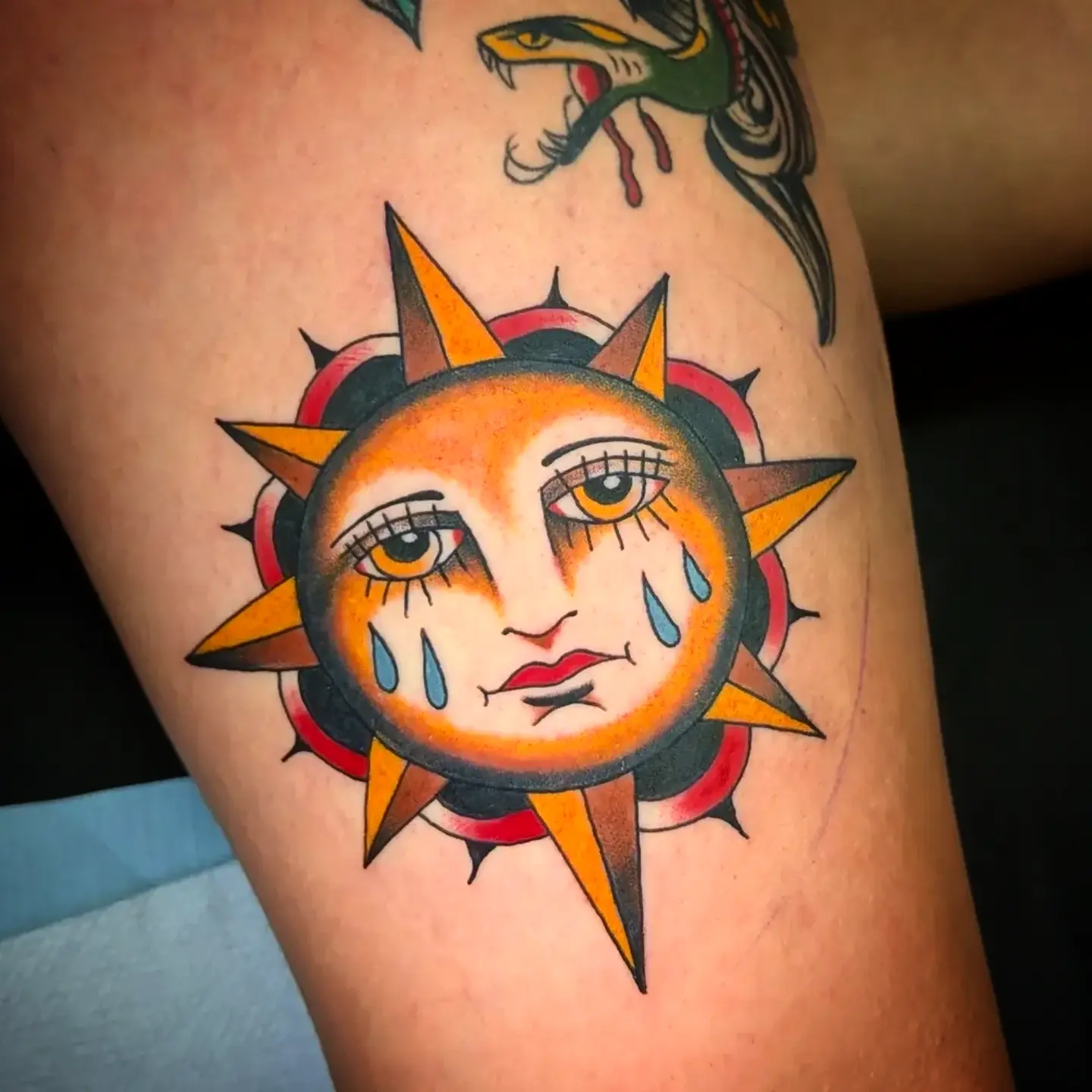 Sad sun American traditional tattoo on the thigh by joseph palladino