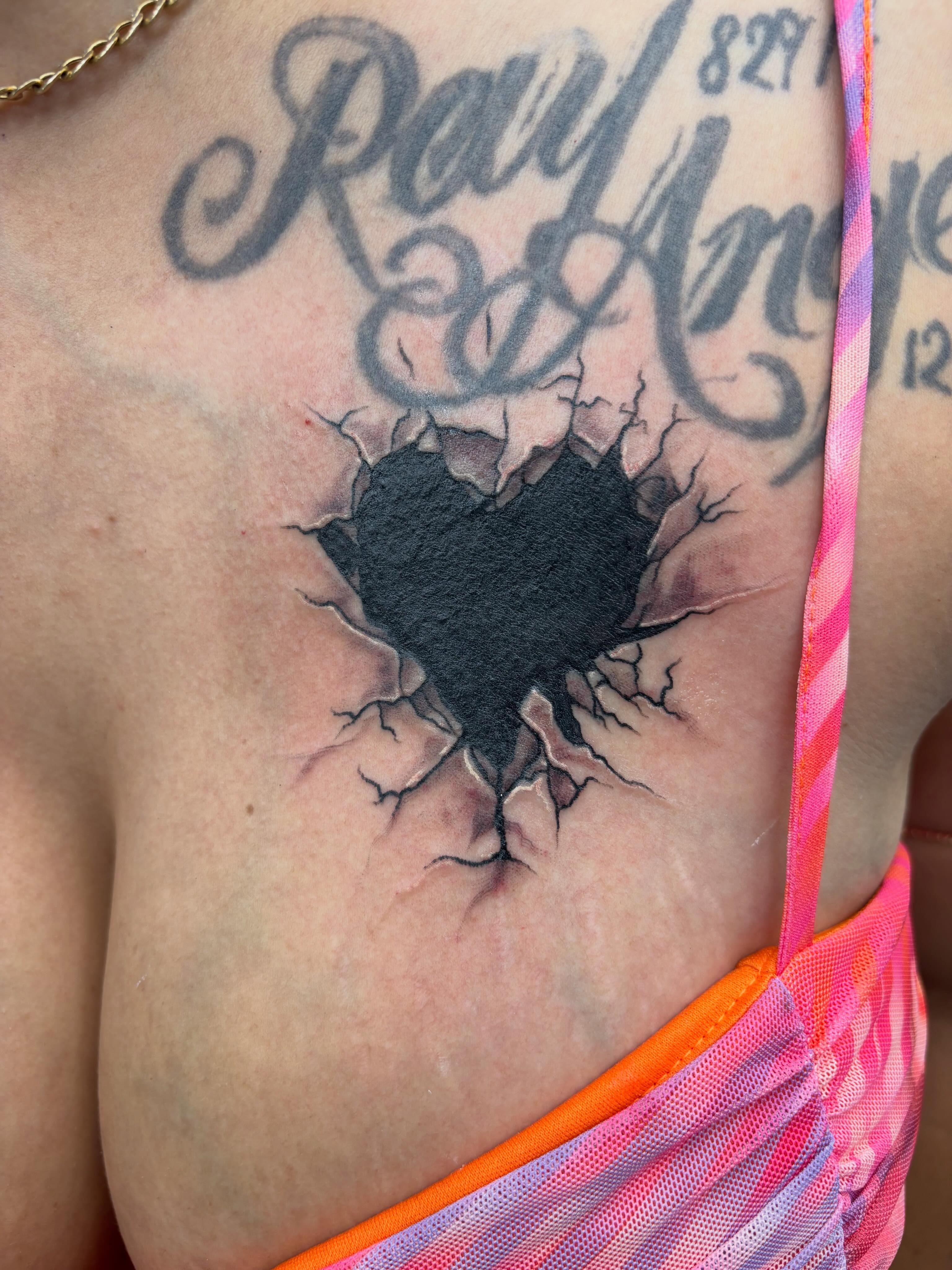 Heart realism tattoo on the chest by Shadows Tattoos