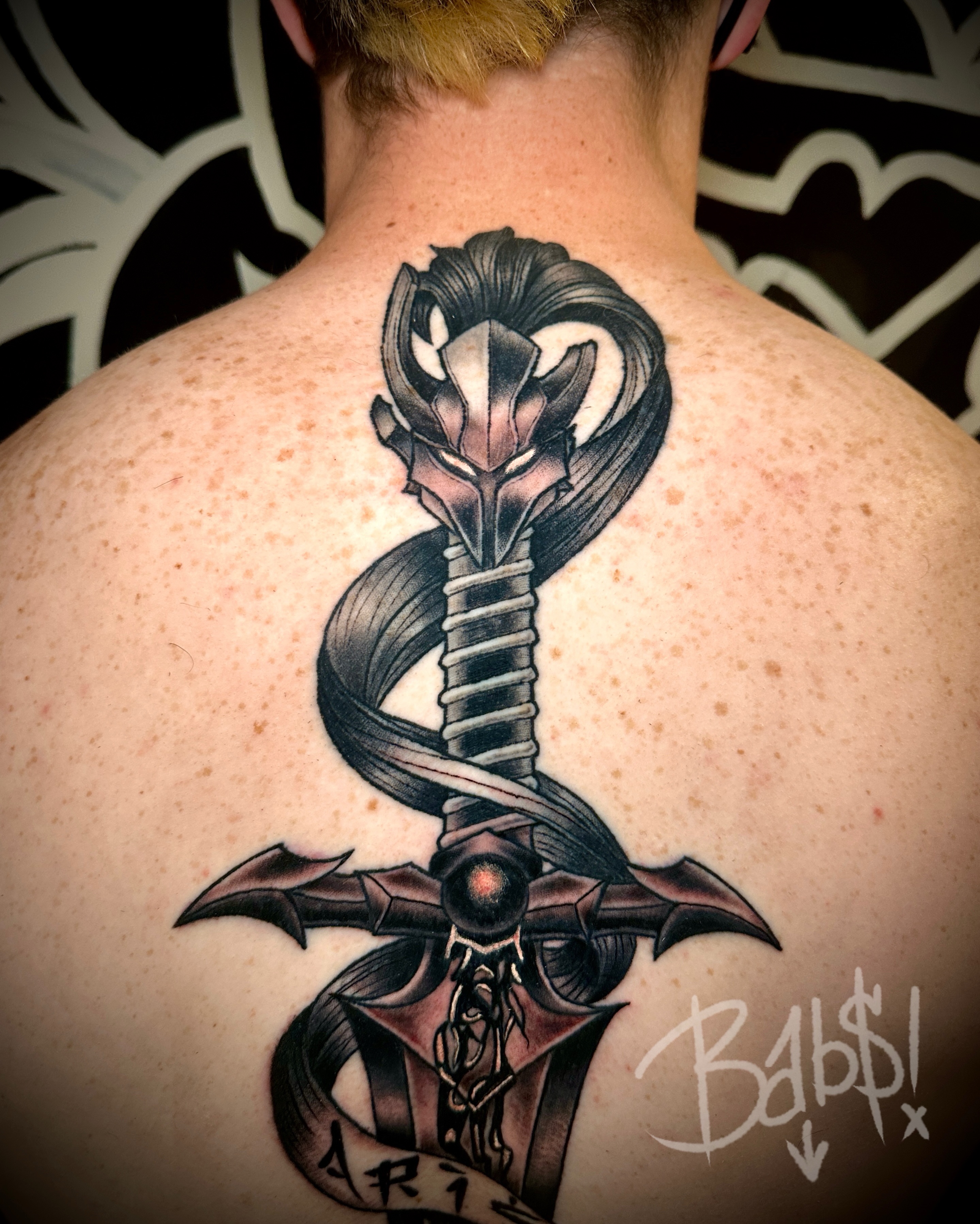Snake and sword realism tattoo on the back by Justin B