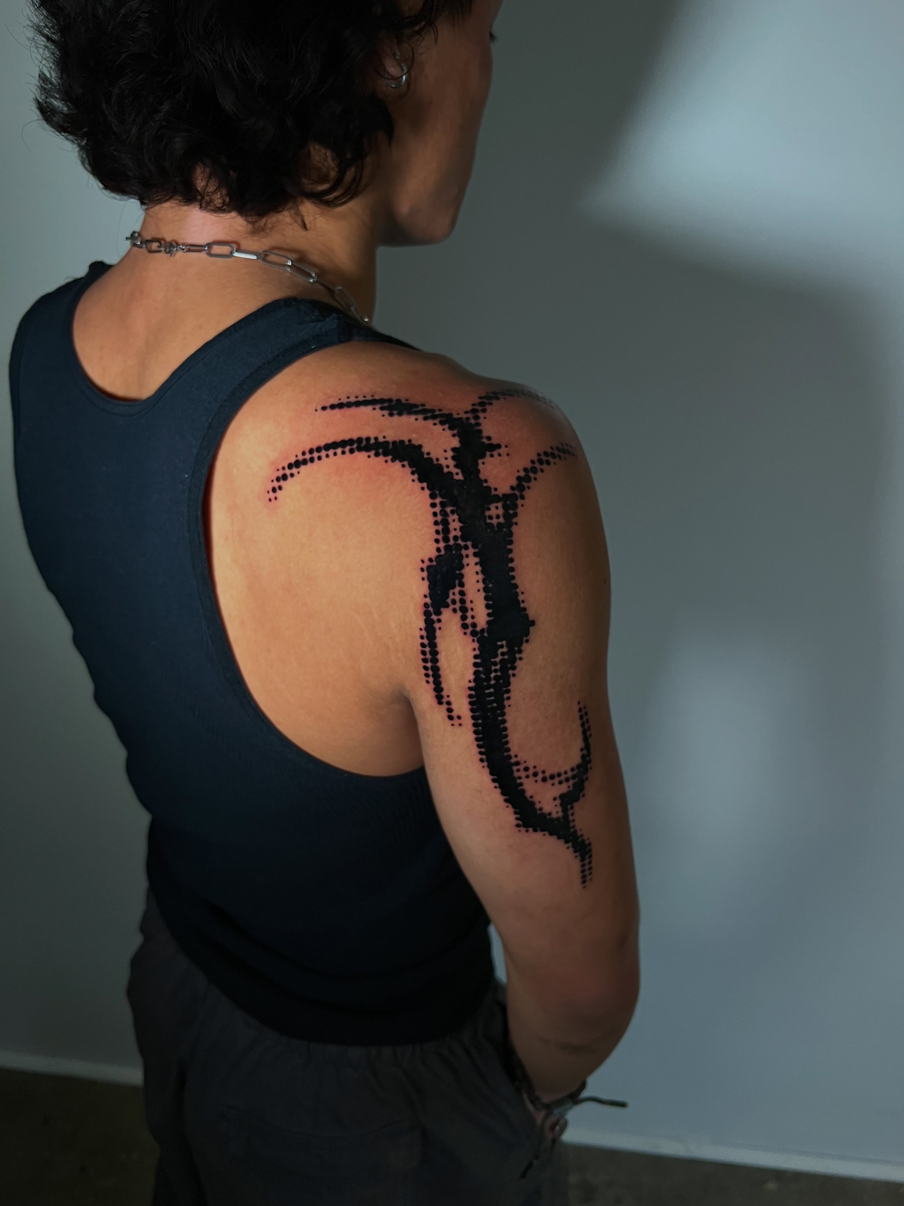 Abstract design dotwork tattoo on the shoulder by Riley