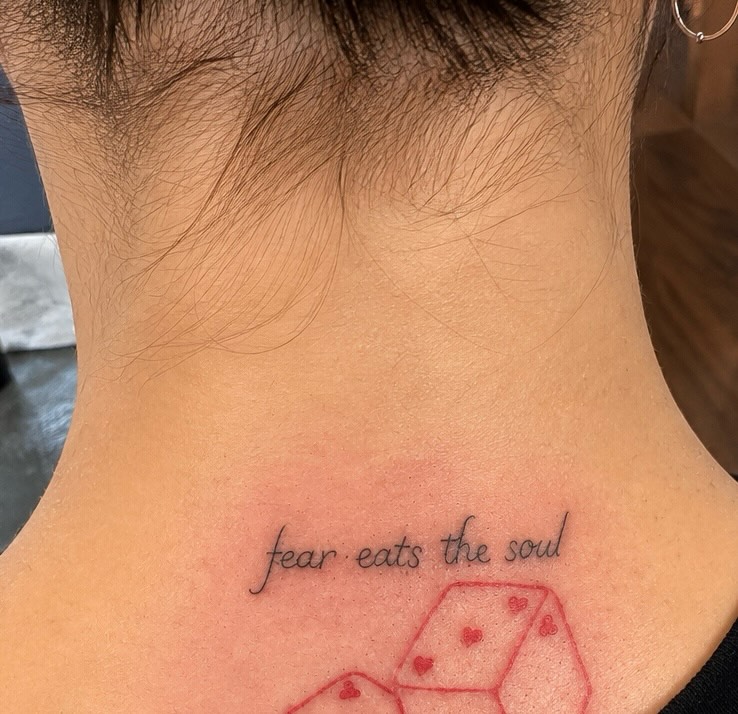 Fear eats the soul lettering script tattoo on the neck by Victoria Cooper