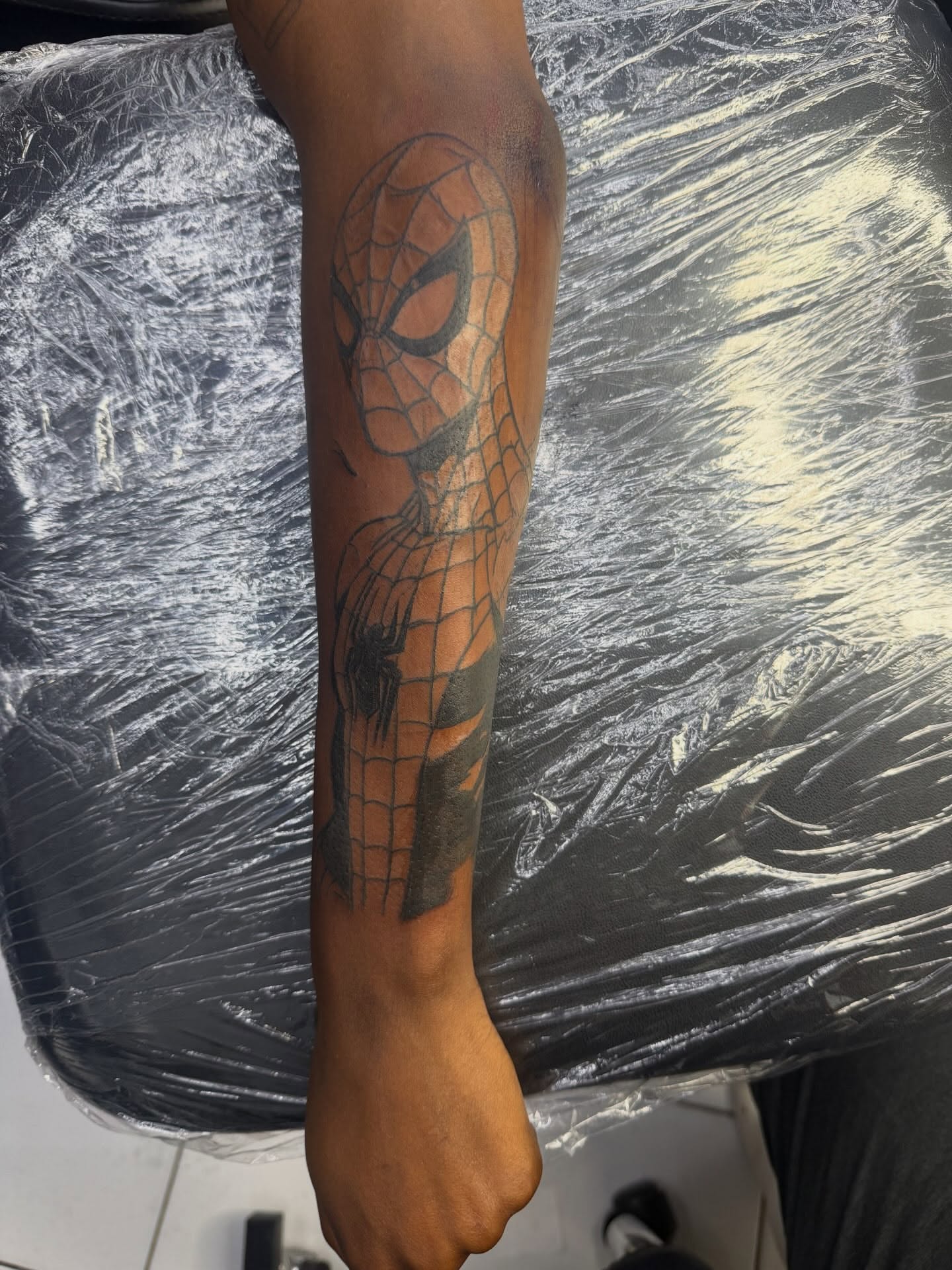Spiderman black and grey tattoo on the forearm by Anthony Washington, Atlanta, Georgia