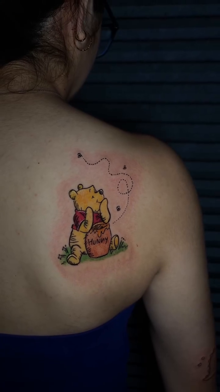 Winnie the Pooh with honey pot new school tattoo on the back by clarissa