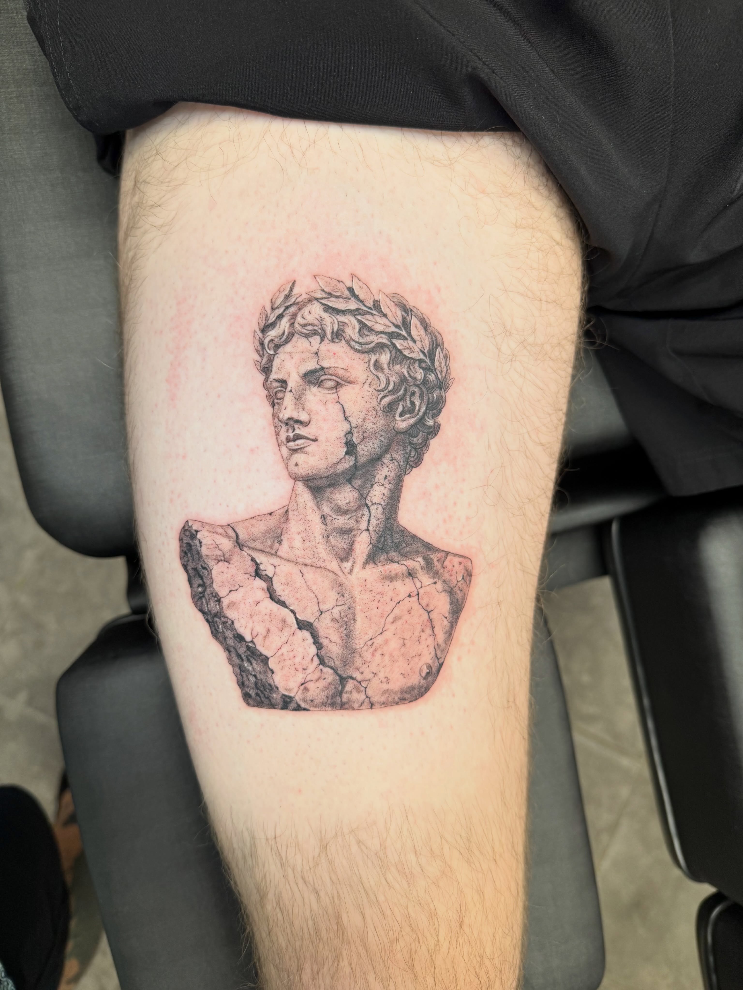 Statue bust realism tattoo on the thigh by Juan Guzman
