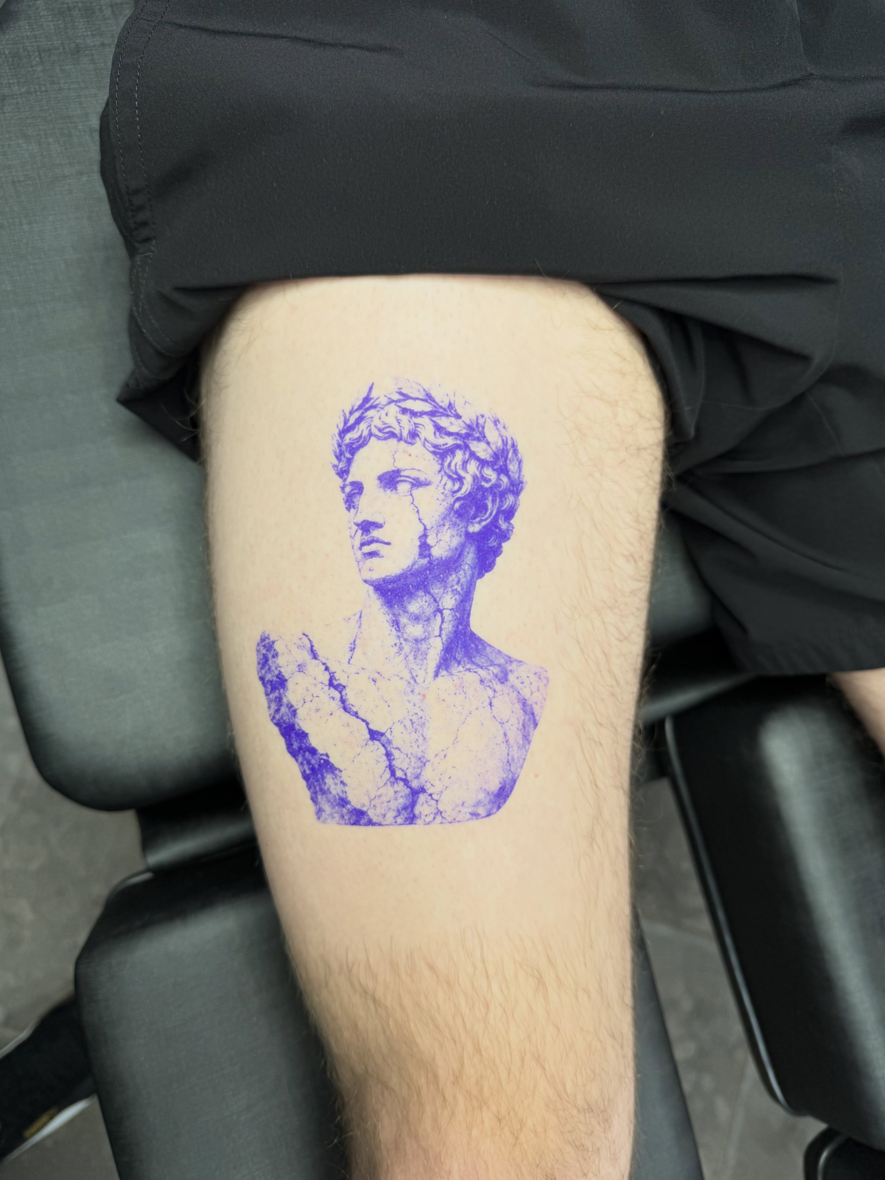 Statue bust black and grey tattoo on the thigh by Juan Guzman