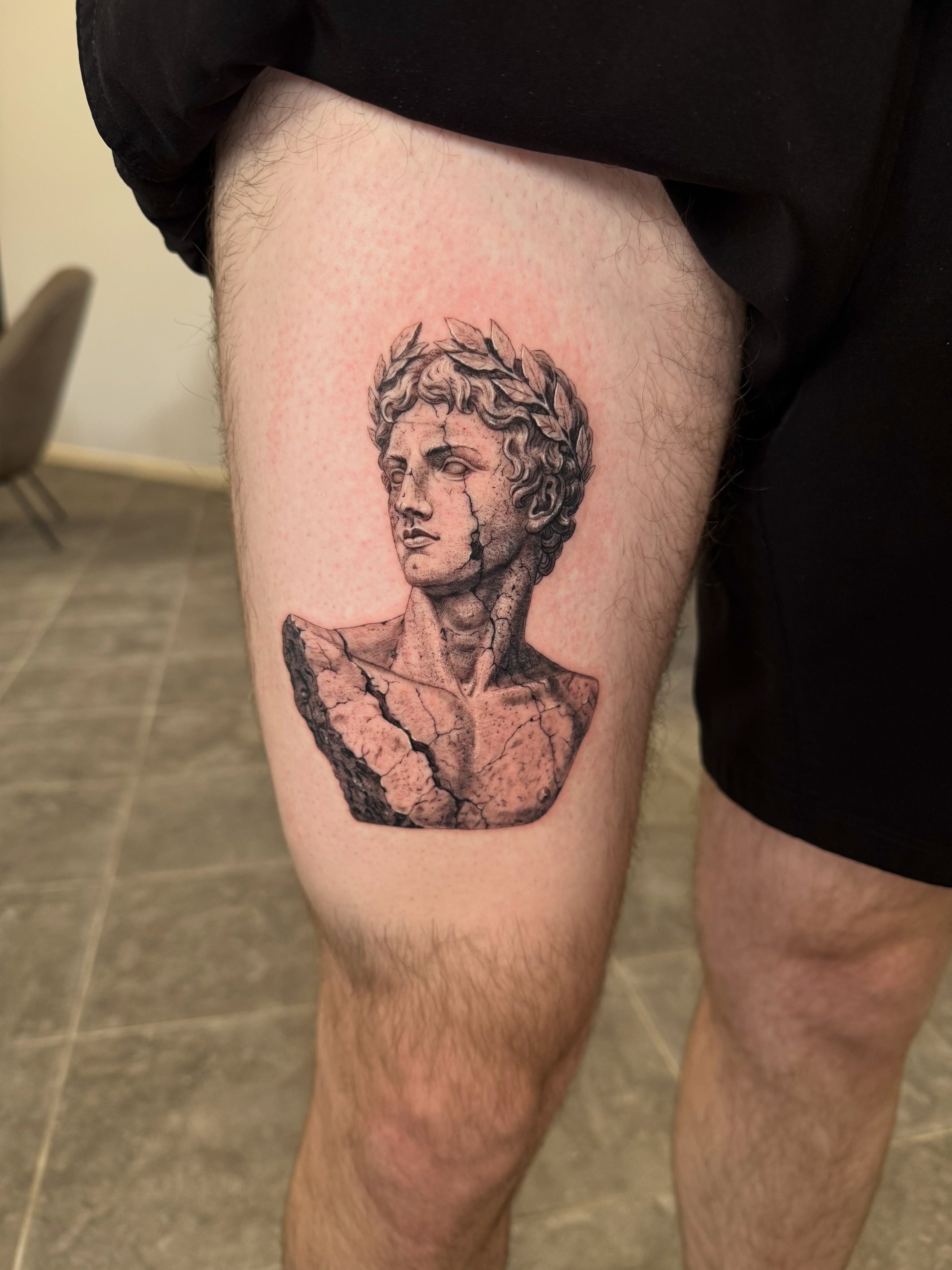 Statue bust realism tattoo on the thigh by Juan Guzman