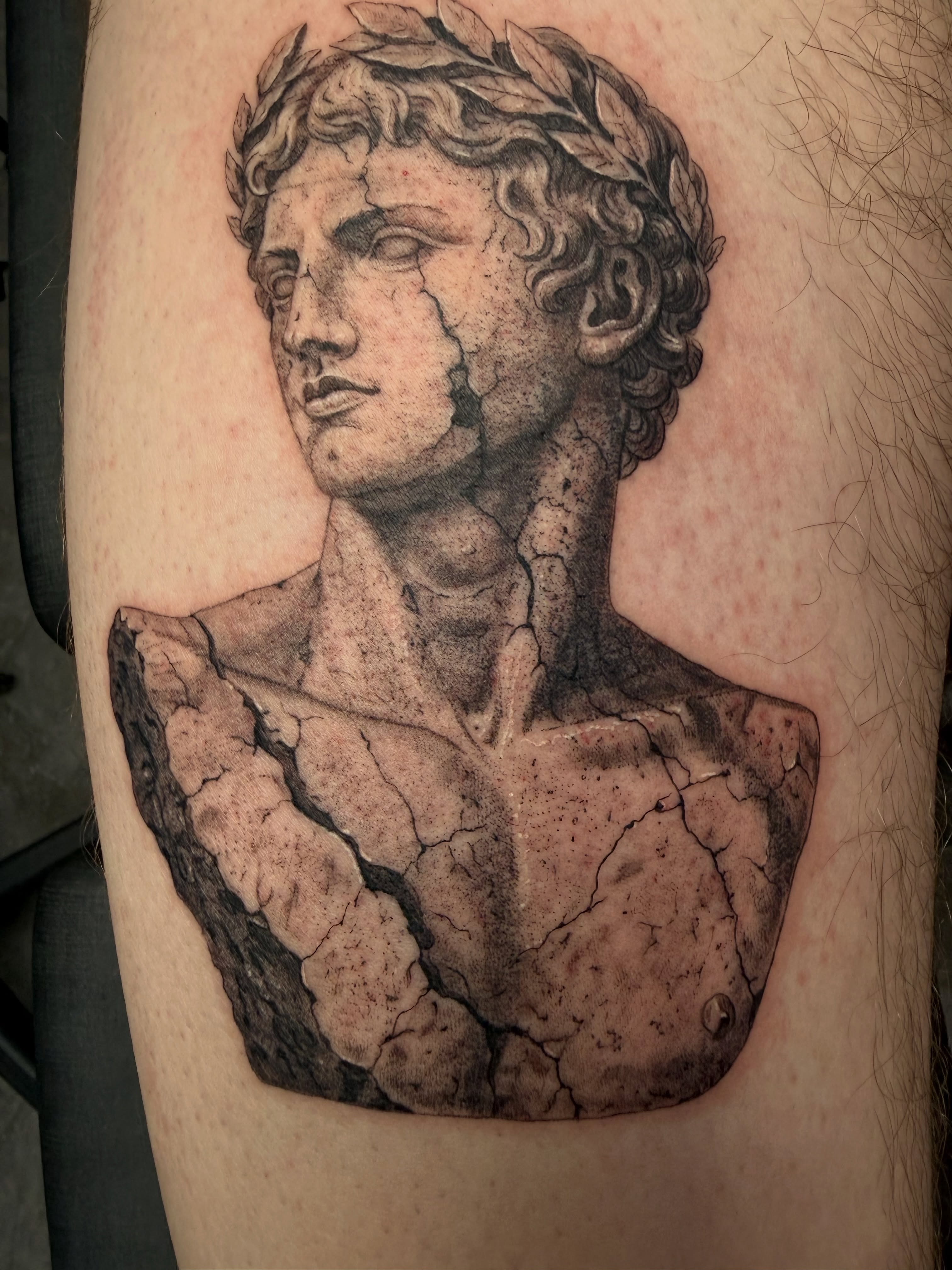 Statue bust realism tattoo on the thigh by Juan Guzman