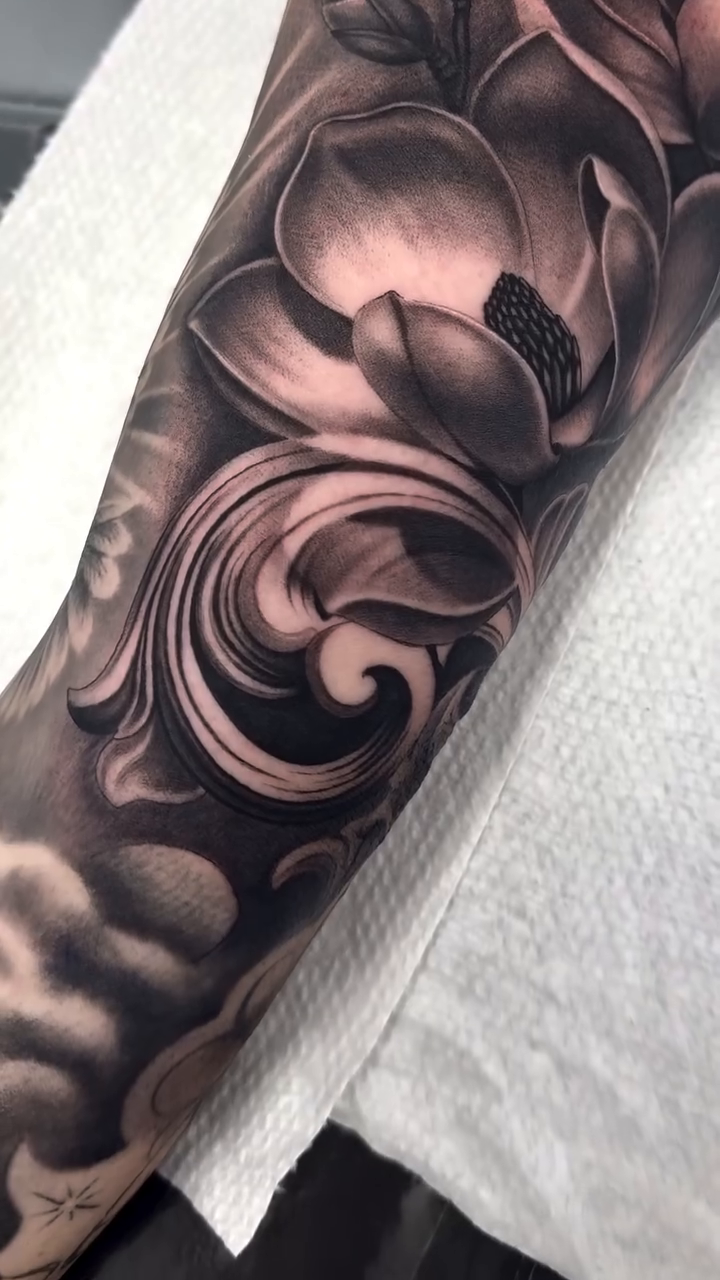 Magnolia flowers and ornate scrollwork realism tattoo by Fernando Andrade Jr