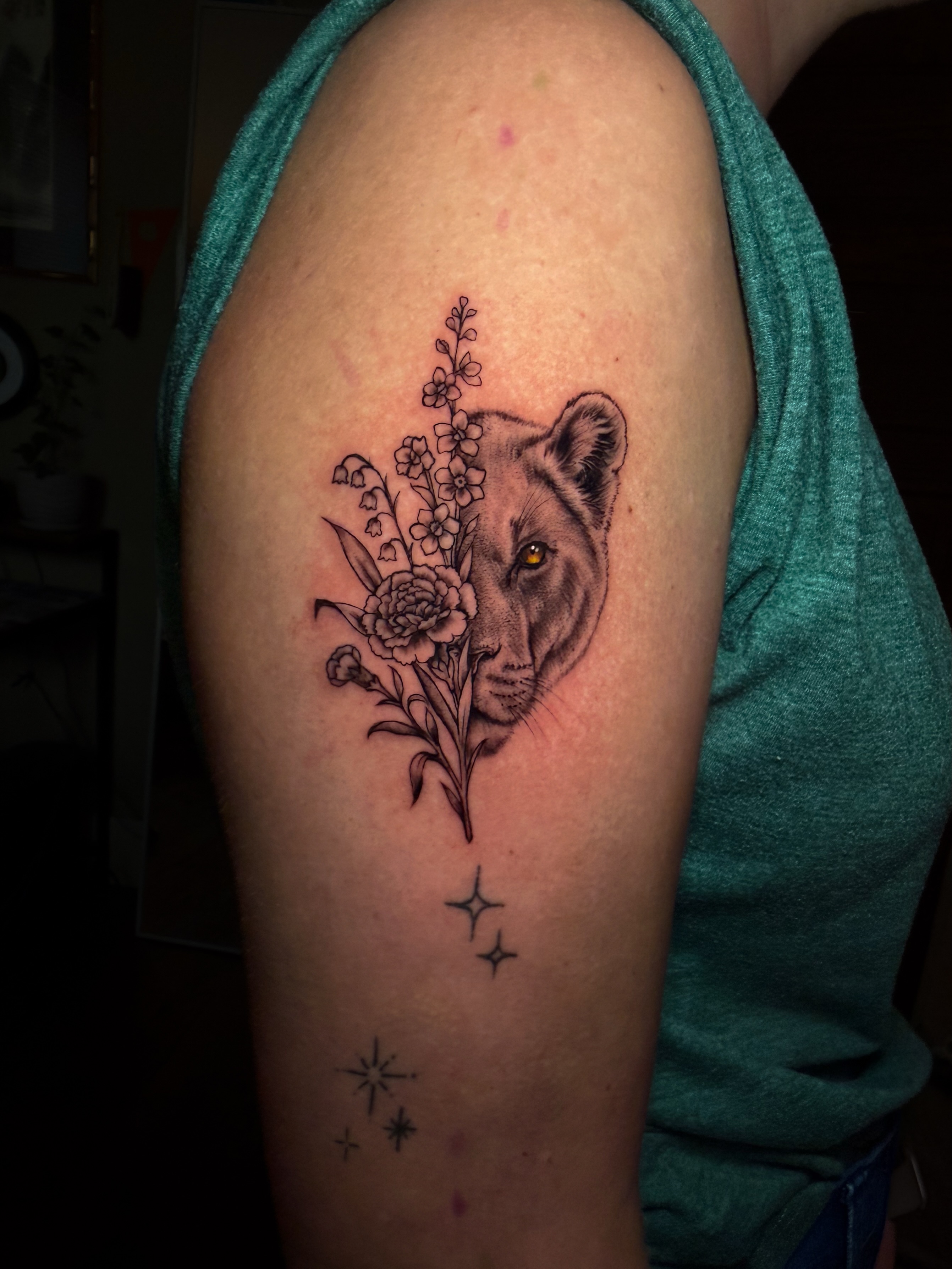 Lioness with flowers realism tattoo on the forearm by Brandt Norcross