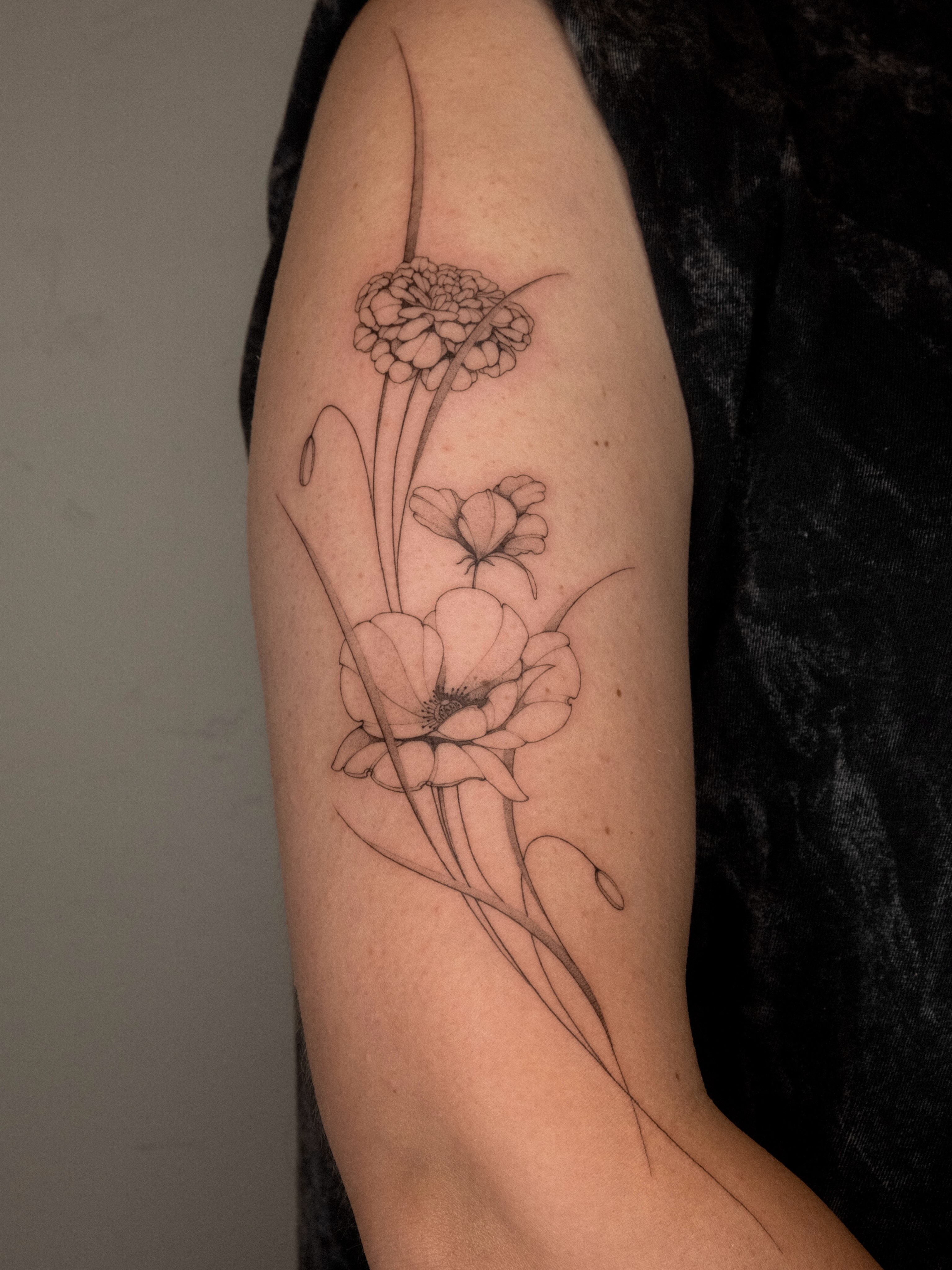 Flowers fine line tattoo on the forearm by ๐๐๐ฆ ๐๐ ๐ฎ๐ฒ๐๐ง