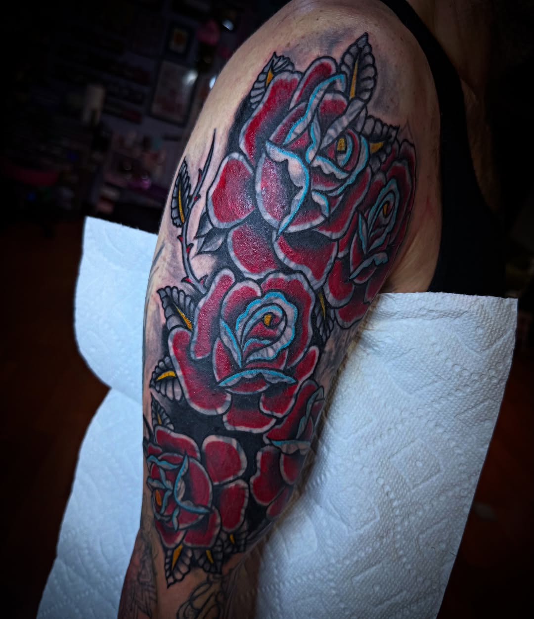 Roses American traditional tattoo on the upper arm by Randi Frey