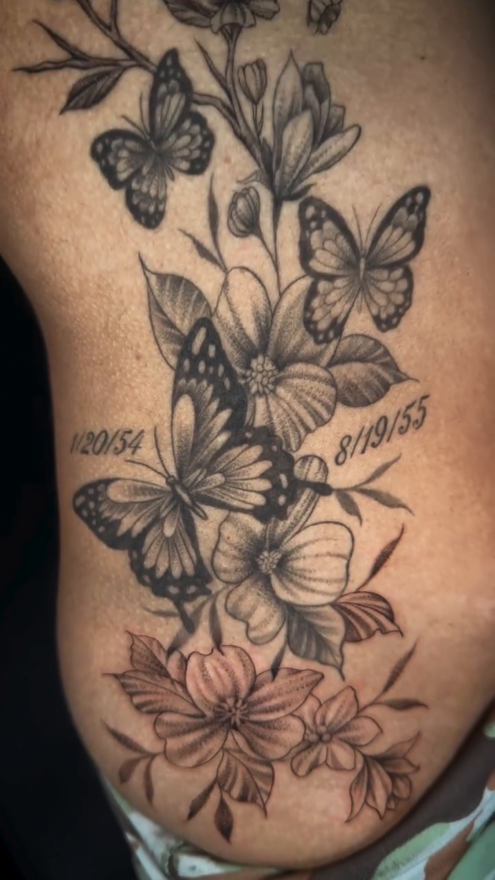 Butterflies and flowers with dates fine line tattoo on the ribs by Monica Gonzalez
