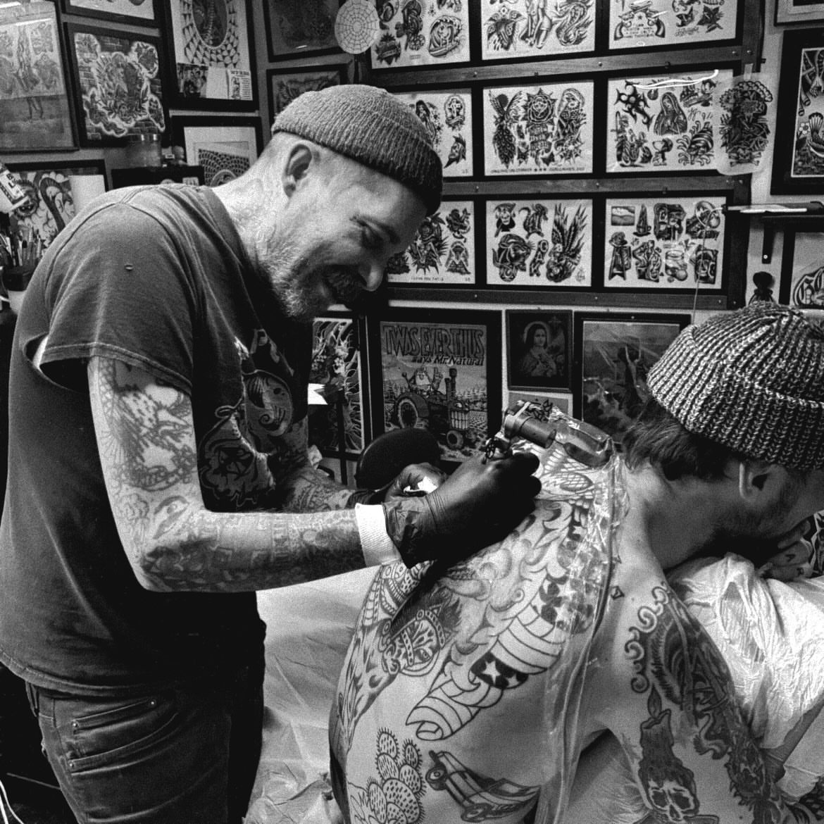 Tattoo artist and client American traditional tattoo on the back by Mike Hudgins