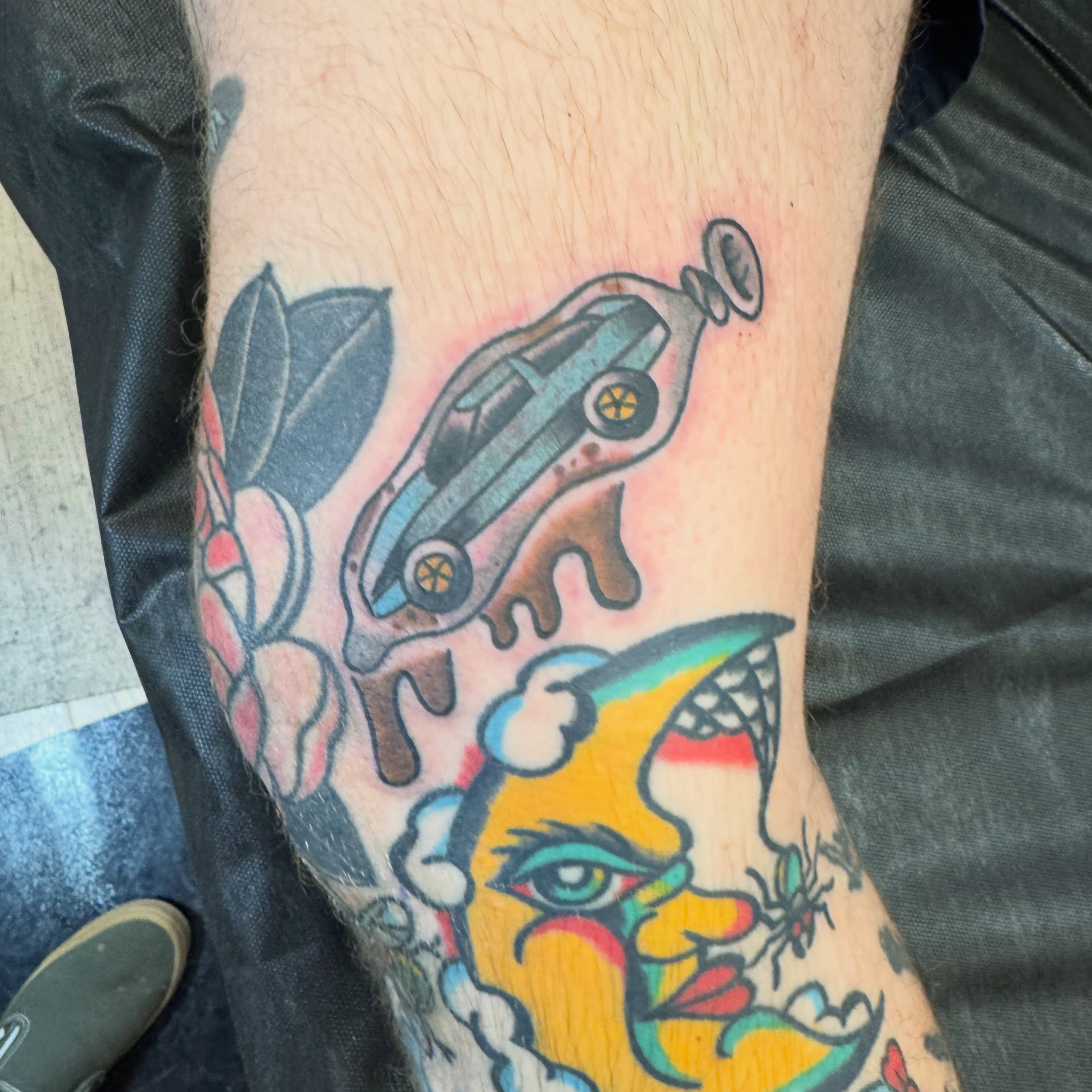 Car melting into face American traditional tattoo on the forearm by Justin Chapman, Des Moines, Iowa