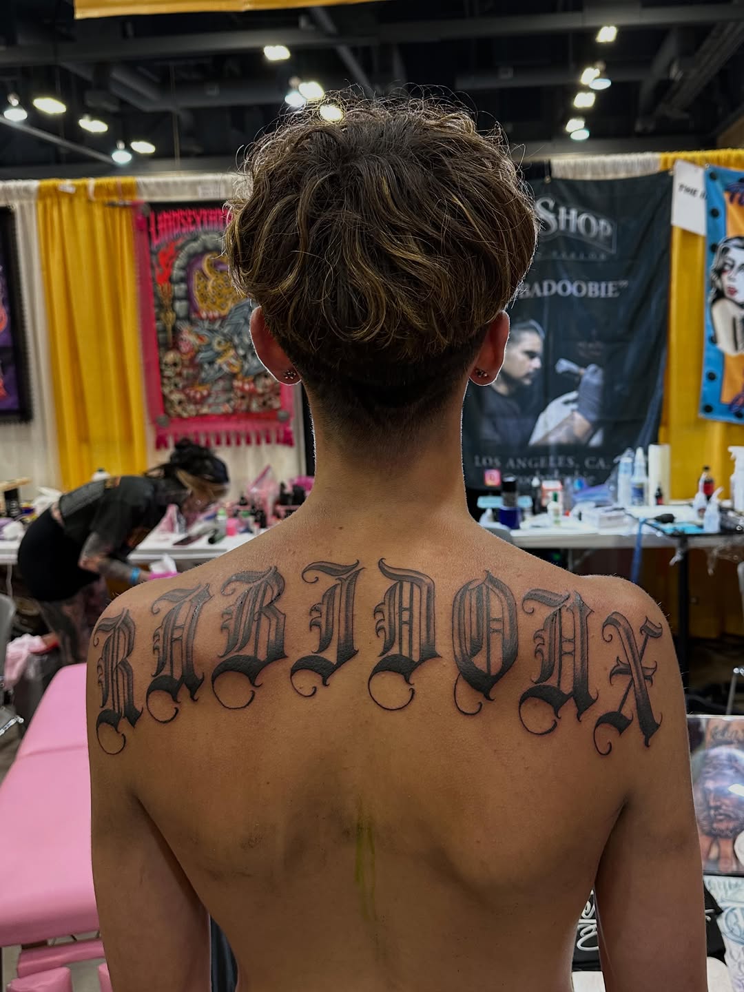 Old English lettering tattoo on the back by Ruben