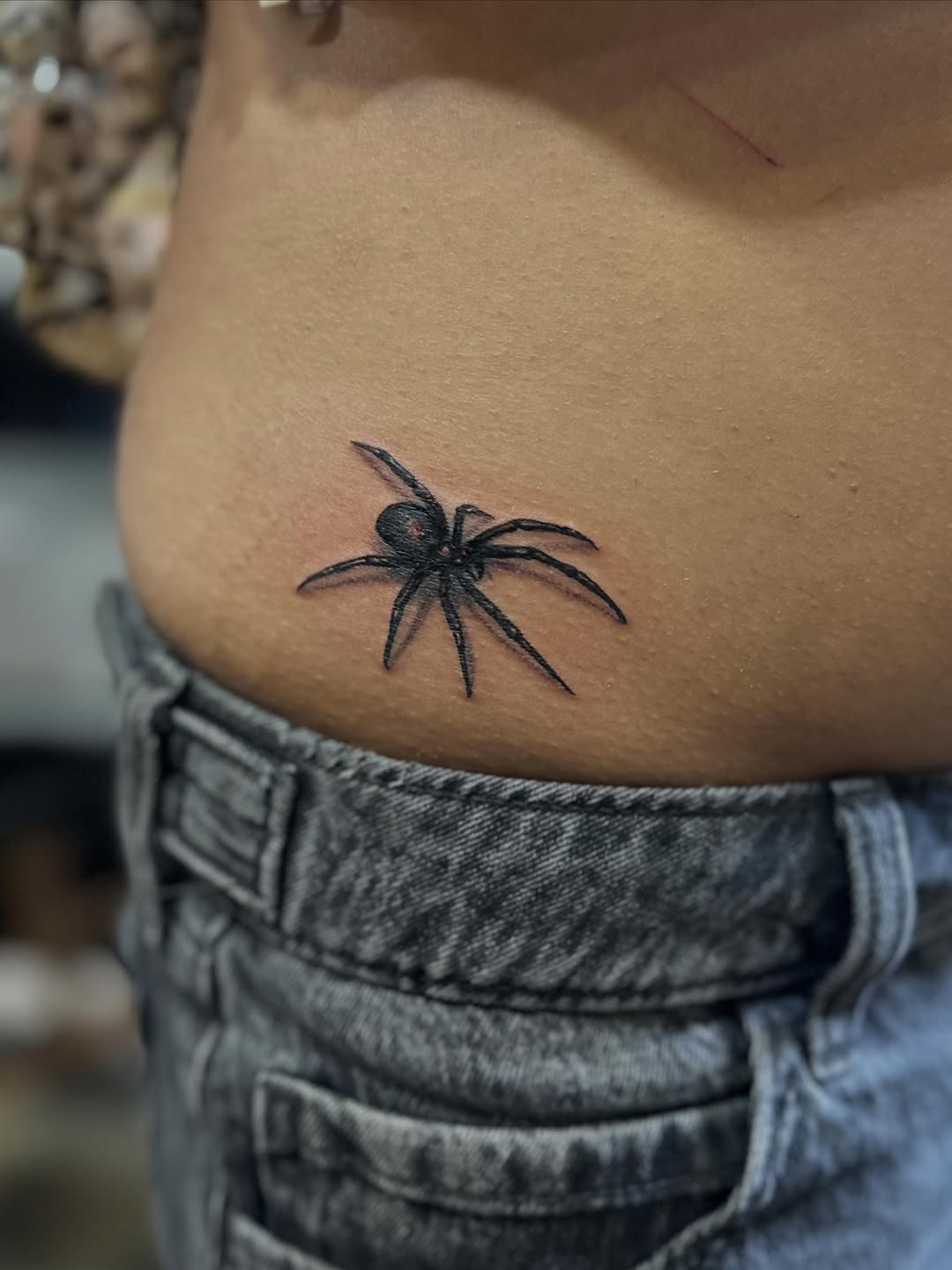 Spider blackwork tattoo on the ribs by Ruben