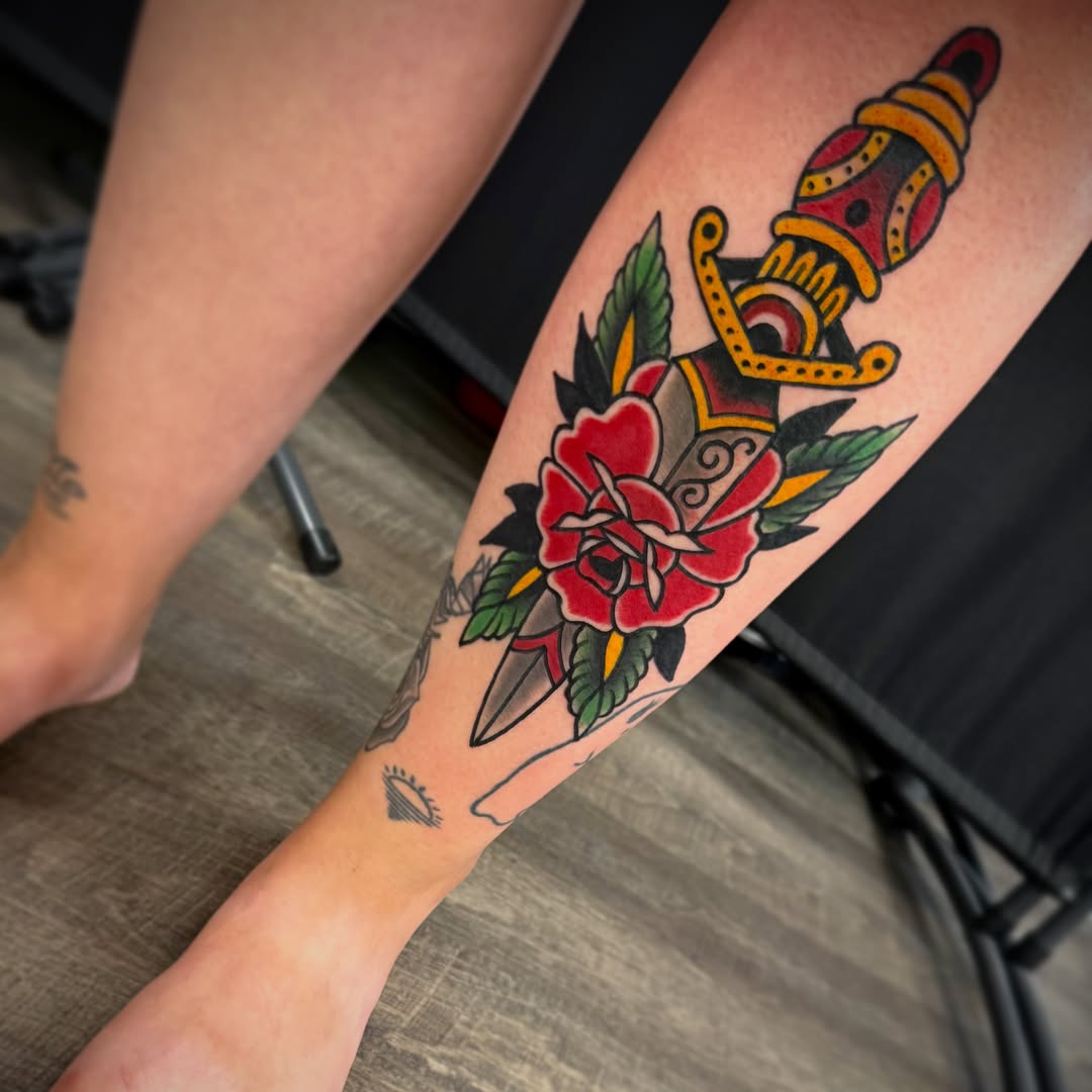 Rose and dagger American traditional tattoo on the forearm by Alec Bauer