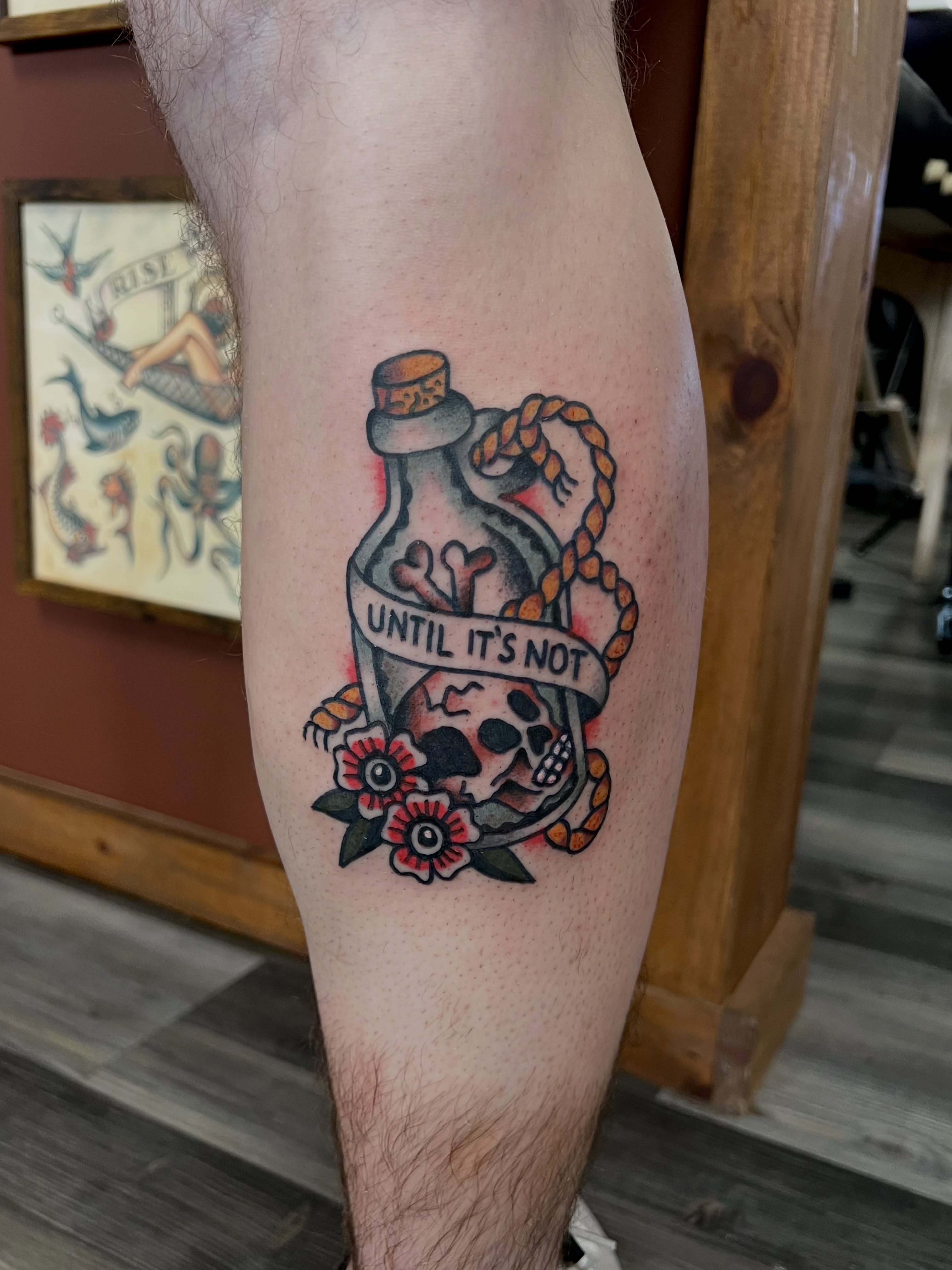 Bottle with skull American traditional tattoo on the forearm by Christopher Durao