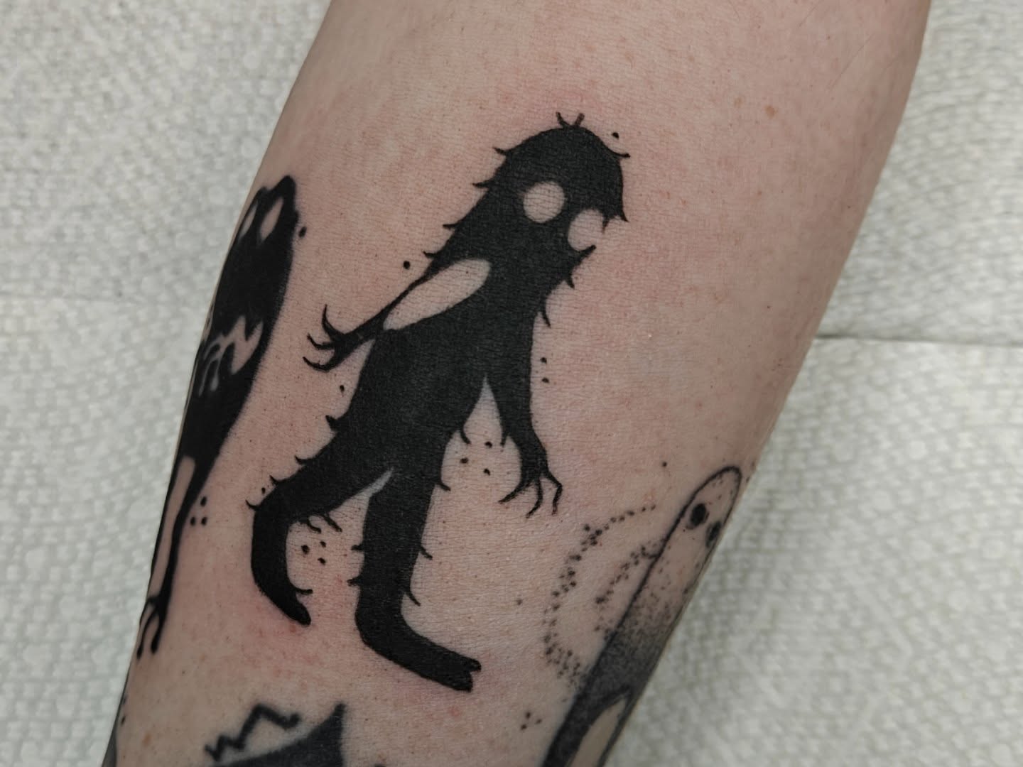 Shadow figure black and grey tattoo on the forearm by Meg